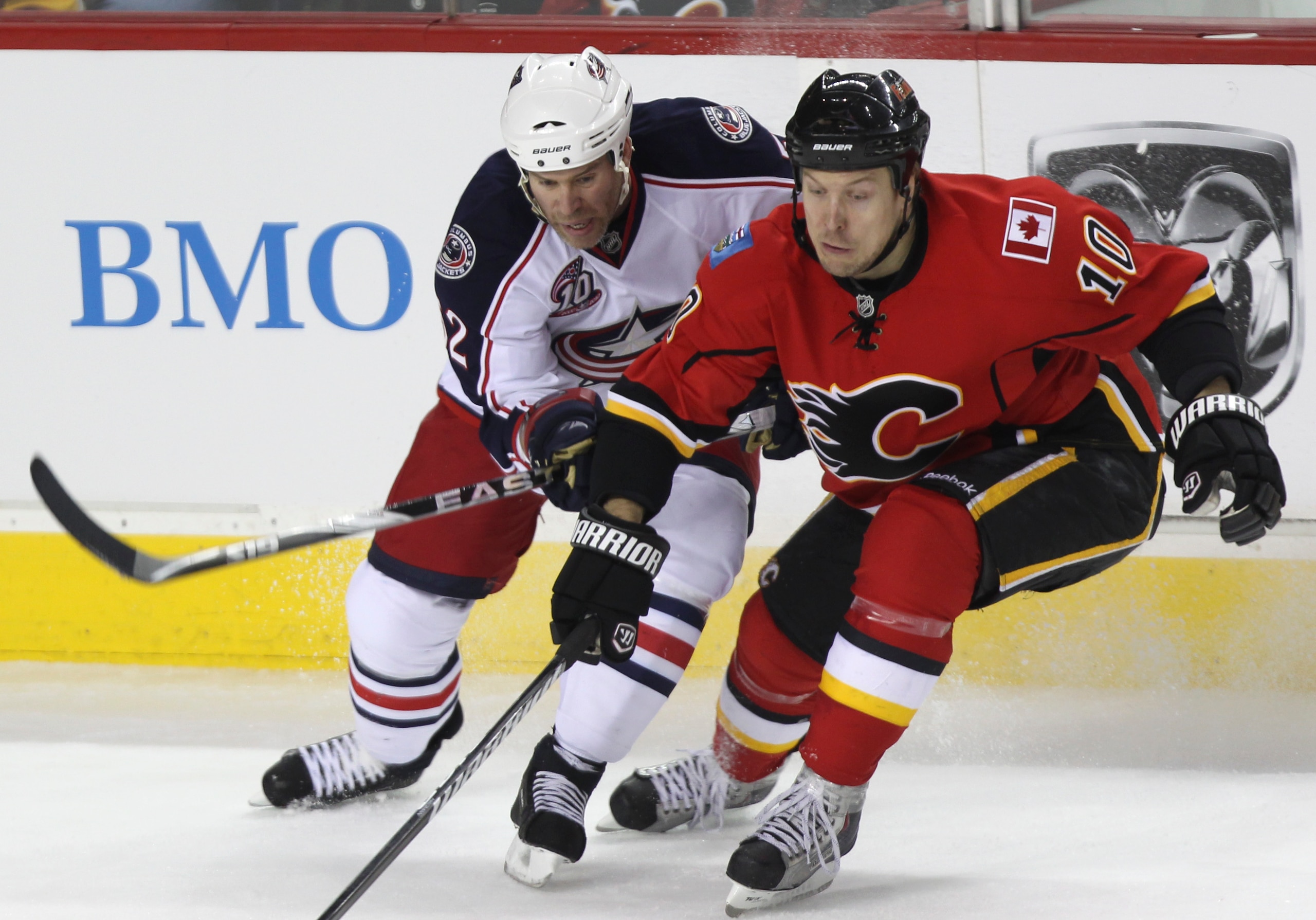 CALGARY, CANADA - MARCH 04:  Niklas Hagman #10 of the Calgary Flames battles with Craig Rivet #52 the Columbus Blue Jackets in the first period of NHL action on March 4, 2011 at the Scotiabank Saddledome in Calgary, Alberta, Canada. (Photo by Mike Ridewoo