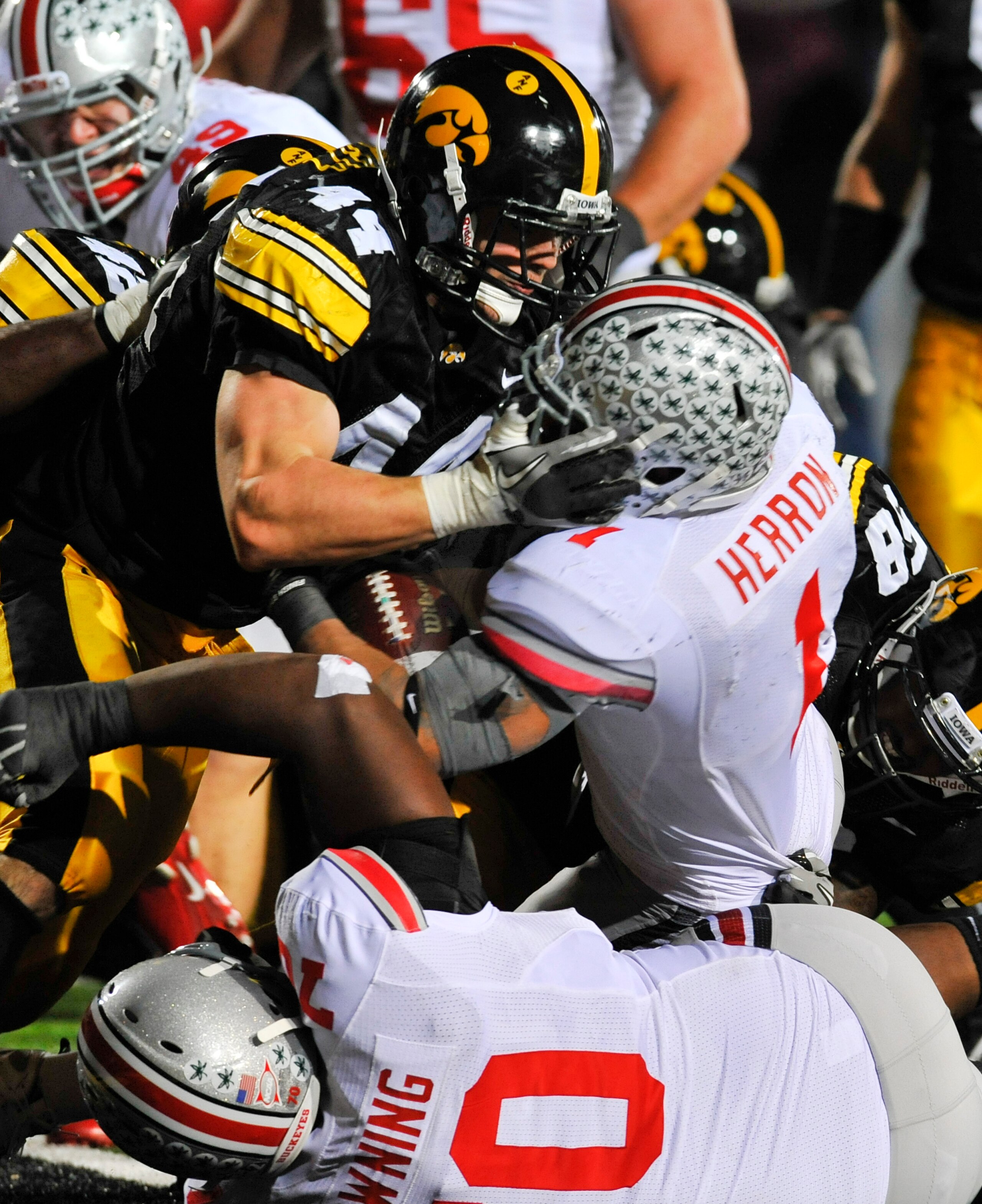 IOWA CITY, IA - NOVEMBER 20: Running back Daniel Herron #1 of the Ohio State Buckeyes drive the ball into the end zone to score a touch down as line backer James Morris #44 of the University of Iowa Hawkeyes defends during the second half of play at Kinni