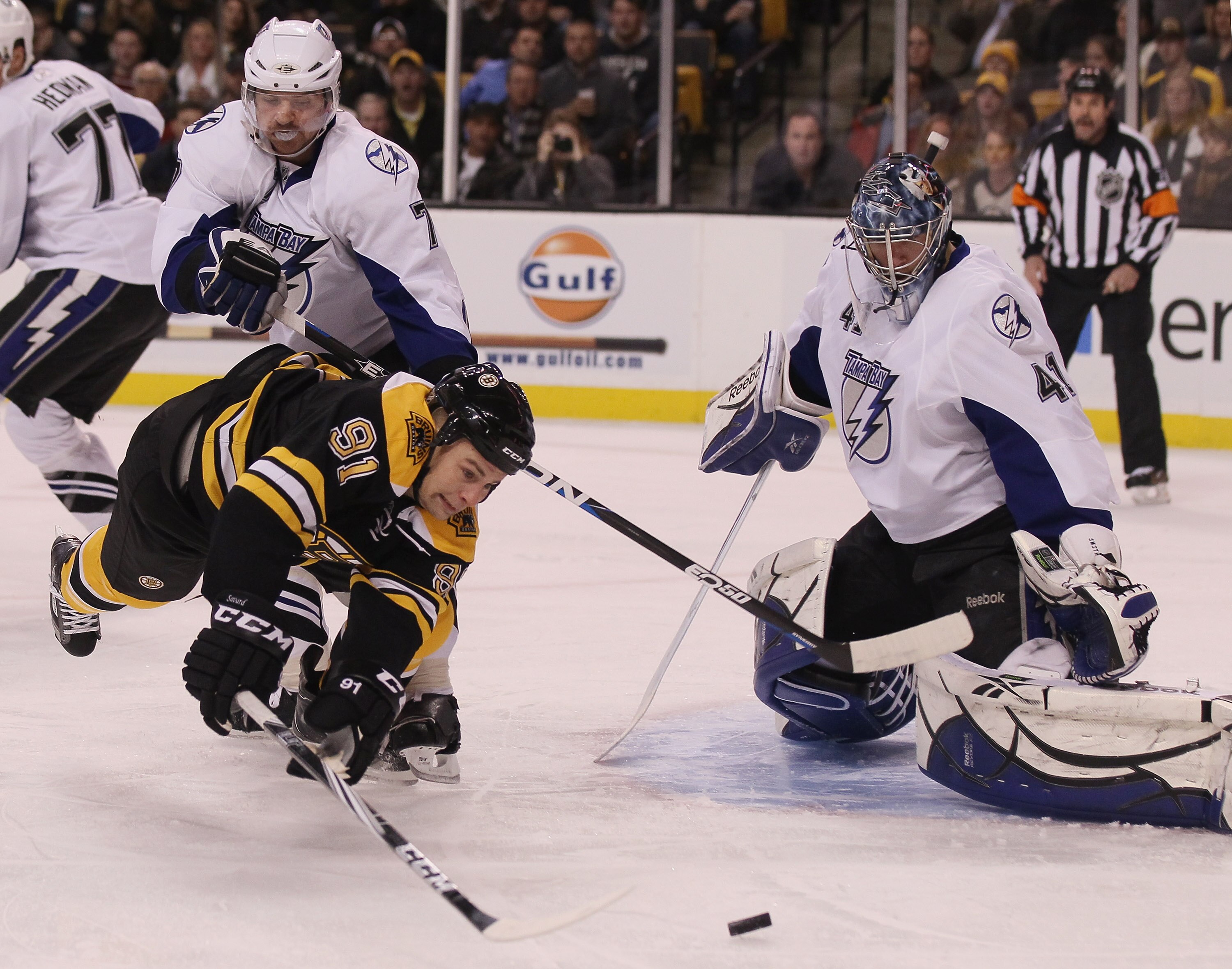BOSTON, MA - DECEMBER 02:  Marc Savard #91 of the Boston Bruins tries to get a shot past Mike Smith #41 of the Tampa Bay Lightning as Brett Clark #7 of the Lightning defends on December 2, 2010 at the TD Garden in Boston, Massachusetts.  (Photo by Elsa/Ge