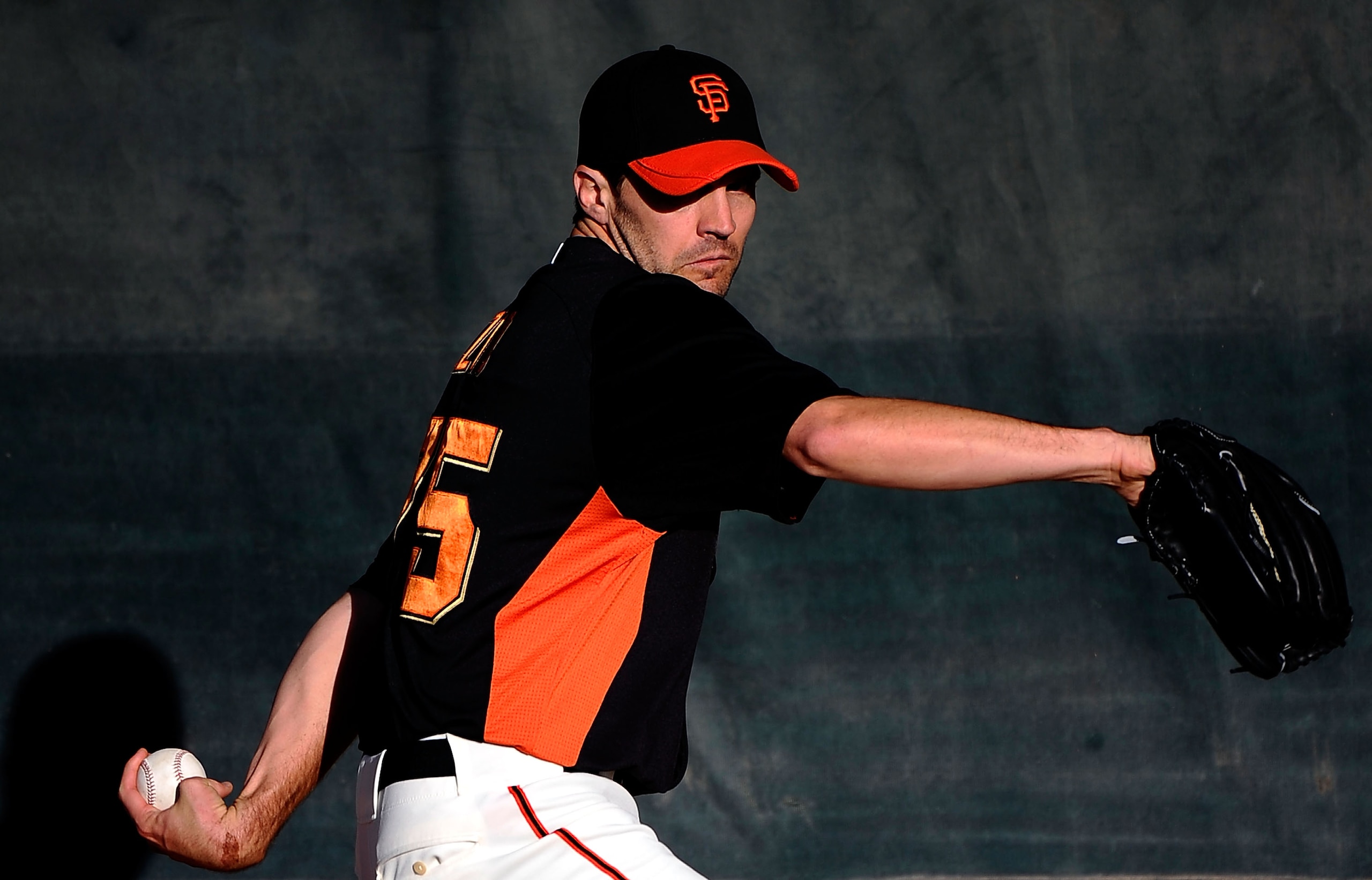 SCOTTSDALE, AZ - MARCH 07:  Pitcher Barry Zito #75 of the San Francisco Giants throws a pitch in the bullpen prior to the start of the spring training baseball game against the Texas Rangers in the first meeting between the two teams since the World Serie