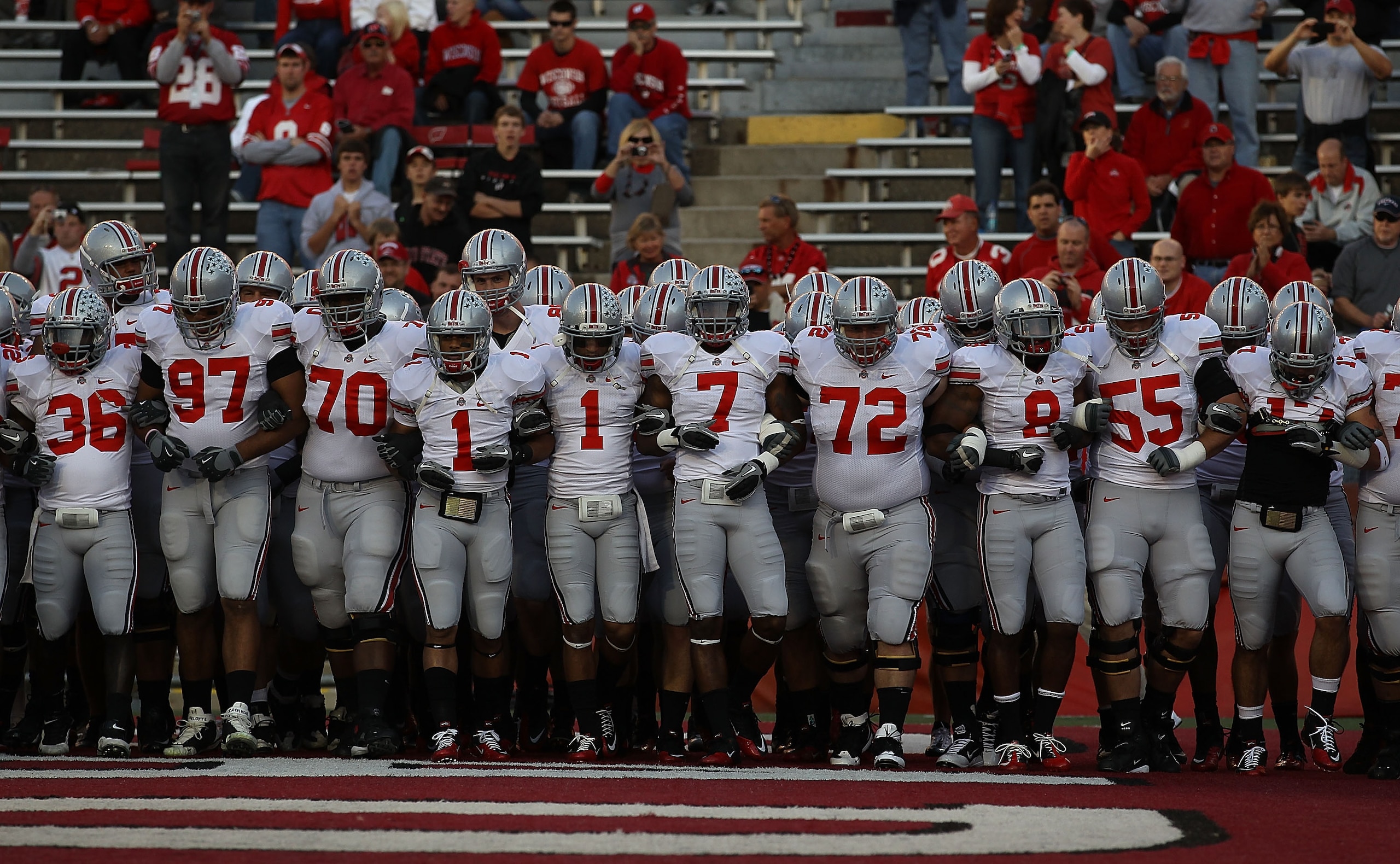 MADISON, WI - OCTOBER 16: Members of the Ohio State Buckeyes including Devon Torrence #1, Jermale Hines #7, Dexter Larimore #72 and Aaron Gant #8 walk on to the field for warm-ups before a game against the Wisconsin Badgers at Camp Randall Stadium on Octo