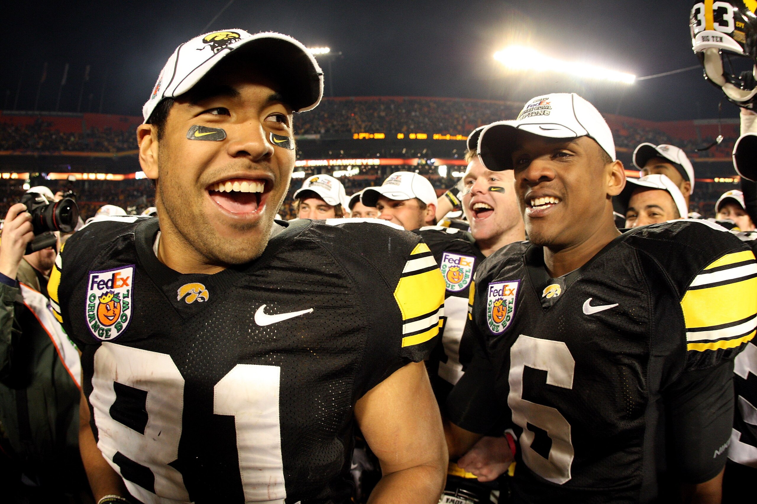MIAMI GARDENS, FL - JANUARY 05:  (L-R) Tony Moeaki #81 and Keenan Davis #6 of the Iowa Hawkeyes celebrate after Iowa won 24-14 against the Georgia Tech Yellow Jackets during the FedEx Orange Bowl at Land Shark Stadium on January 5, 2010 in Miami Gardens,