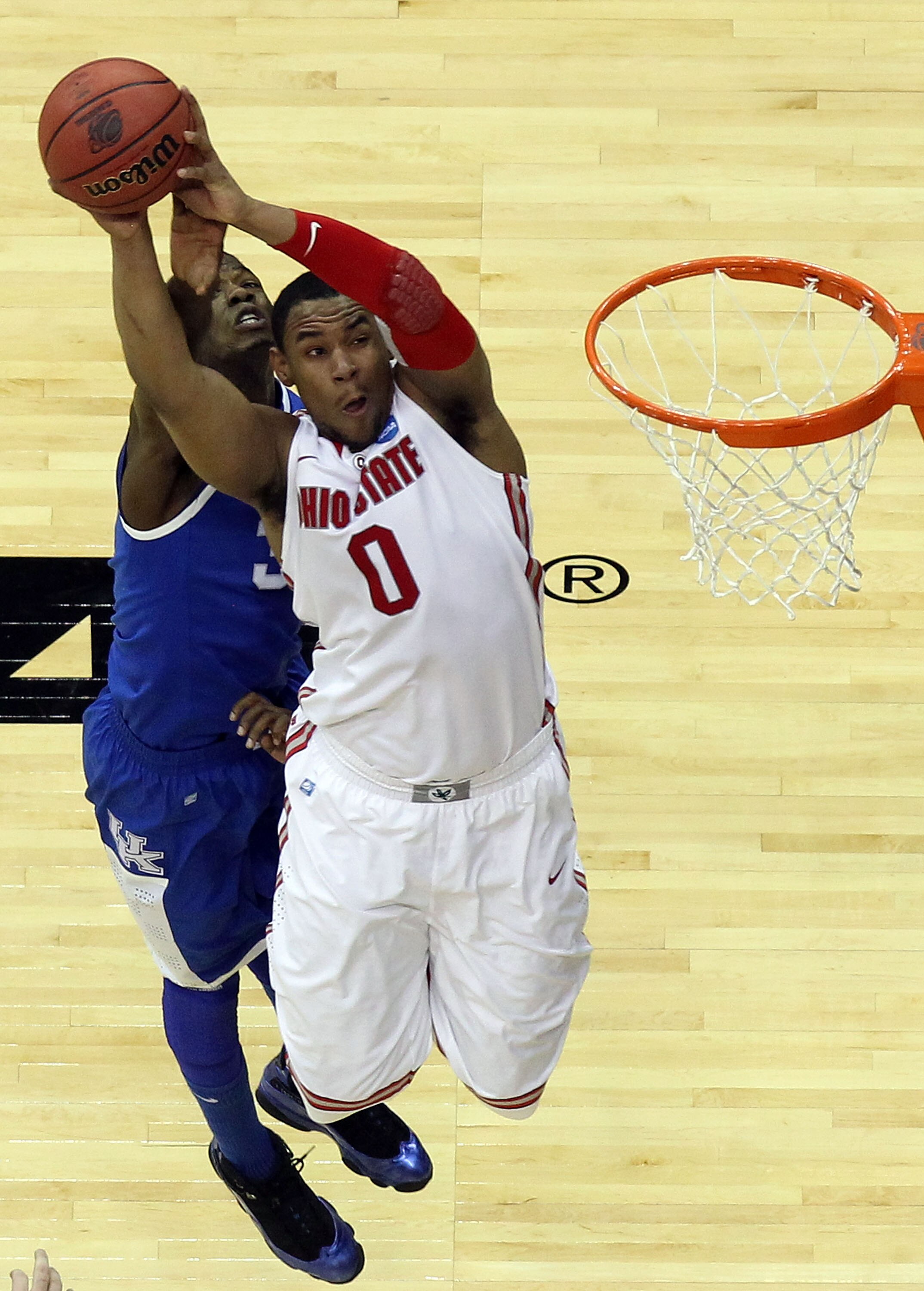 NEWARK, NJ - MARCH 25:  Jared Sullinger #0 of the Ohio State Buckeyes goes for a lay up against DeAndre Liggins #34 of the Kentucky Wildcats during the second half of the east regional semifinal of the 2011 NCAA Men's Basketball Tournament at the Prudenti