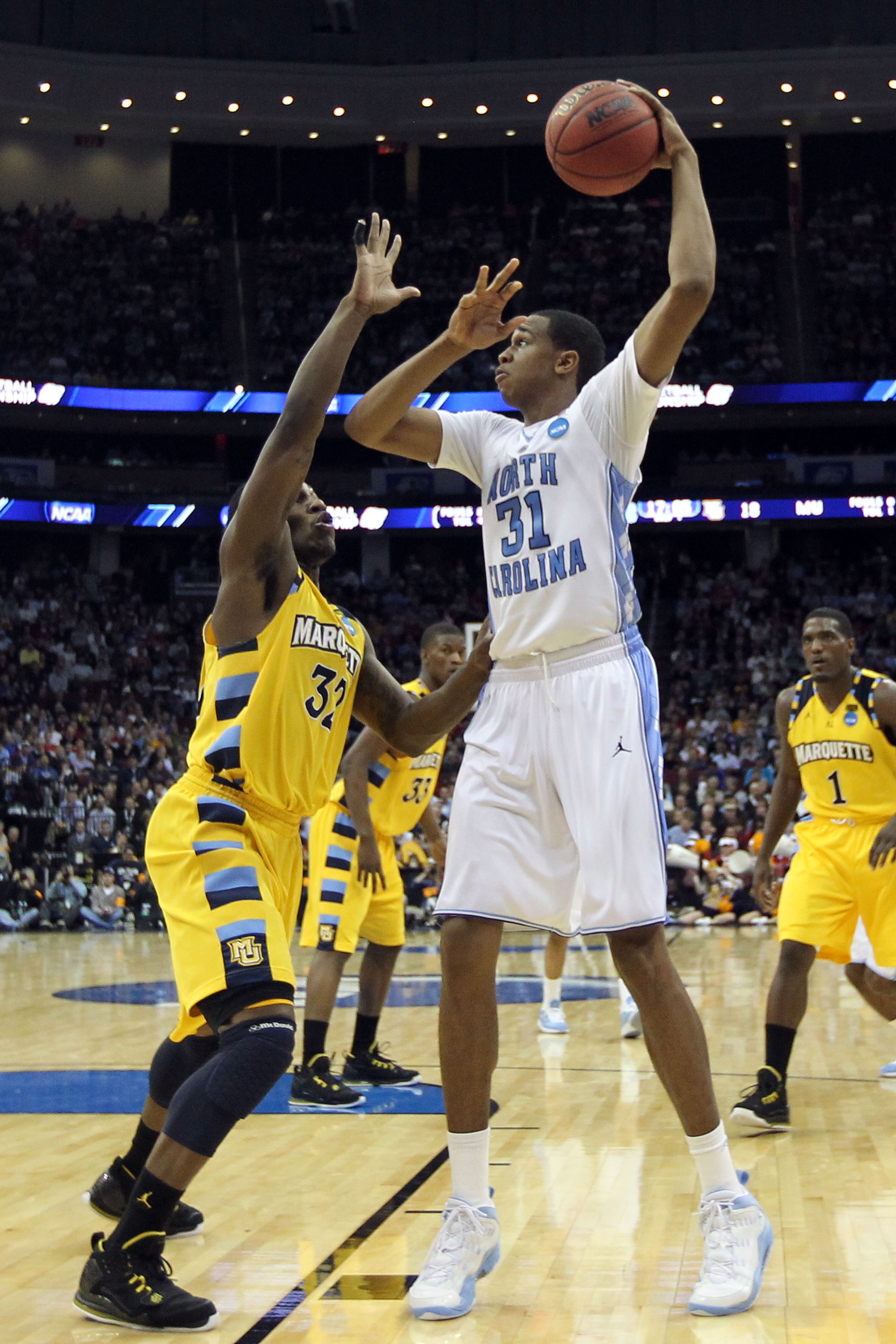 NEWARK, NJ - MARCH 25:  John Henson #31 of the North Carolina Tar Heels against Jae Crowder #32 of the Marquette Golden Eagles during the east regional semifinal of the 2011 NCAA Men's Basketball Tournament at the Prudential Center on March 25, 2011 in Ne