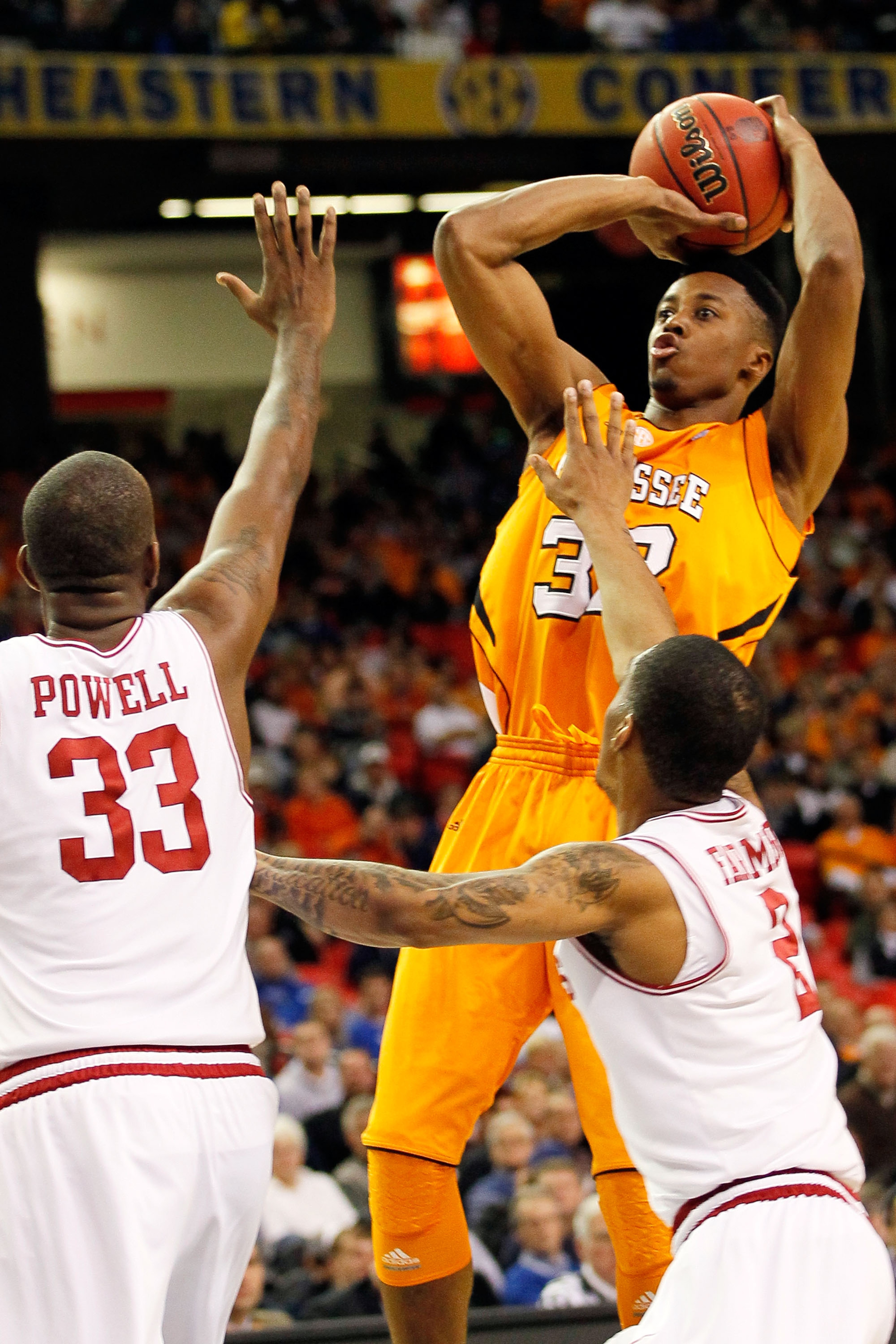 ATLANTA, GA - MARCH 10: Scotty Hopson #32 of the Tennessee Volunteers shoots against Marshawn Powell #33 and Jemal Farmer #2 of the Arkansas Razorbacks during the first round of the SEC Men's Basketball Tournament at the Georgia Dome on March 10, 2011 in ATLANTA, GA - MARCH 10: Scotty Hopson #32 of the Tennessee Volunteers shoots against Marshawn Powell #33 and Jemal Farmer #2 of the Arkansas Razorbacks during the first round of the SEC Men's Basketball Tournament at the Georgia Dome on March 10, 2011 in