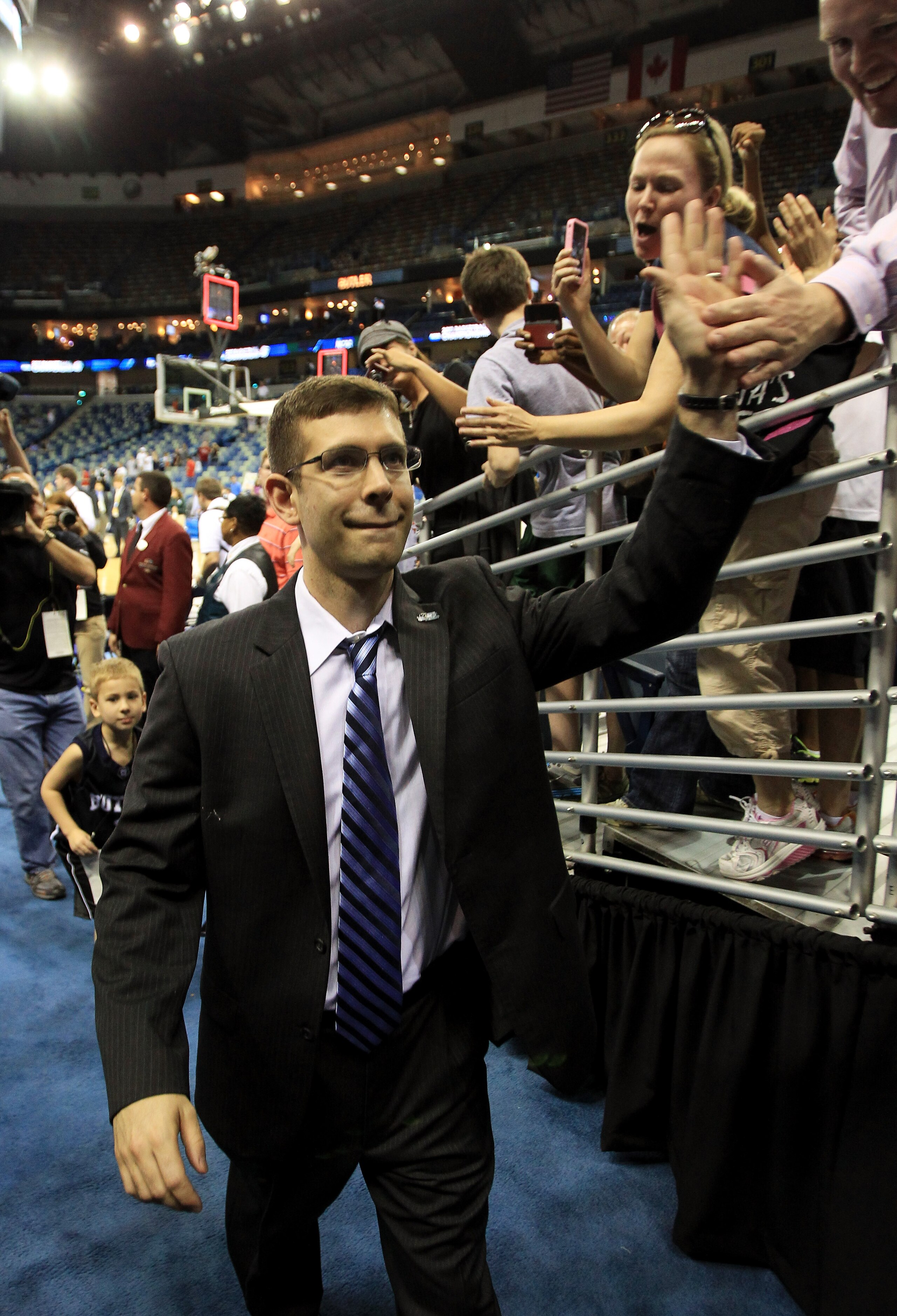 NEW ORLEANS, LA - MARCH 26:  Head coach Brad Stevens of the Butler Bulldogs celebrates with fans after they defeated the Florida Gators 74 to 71 in overtime during the Southeast regional final of the 2011 NCAA men's basketball tournament at New Orleans Ar