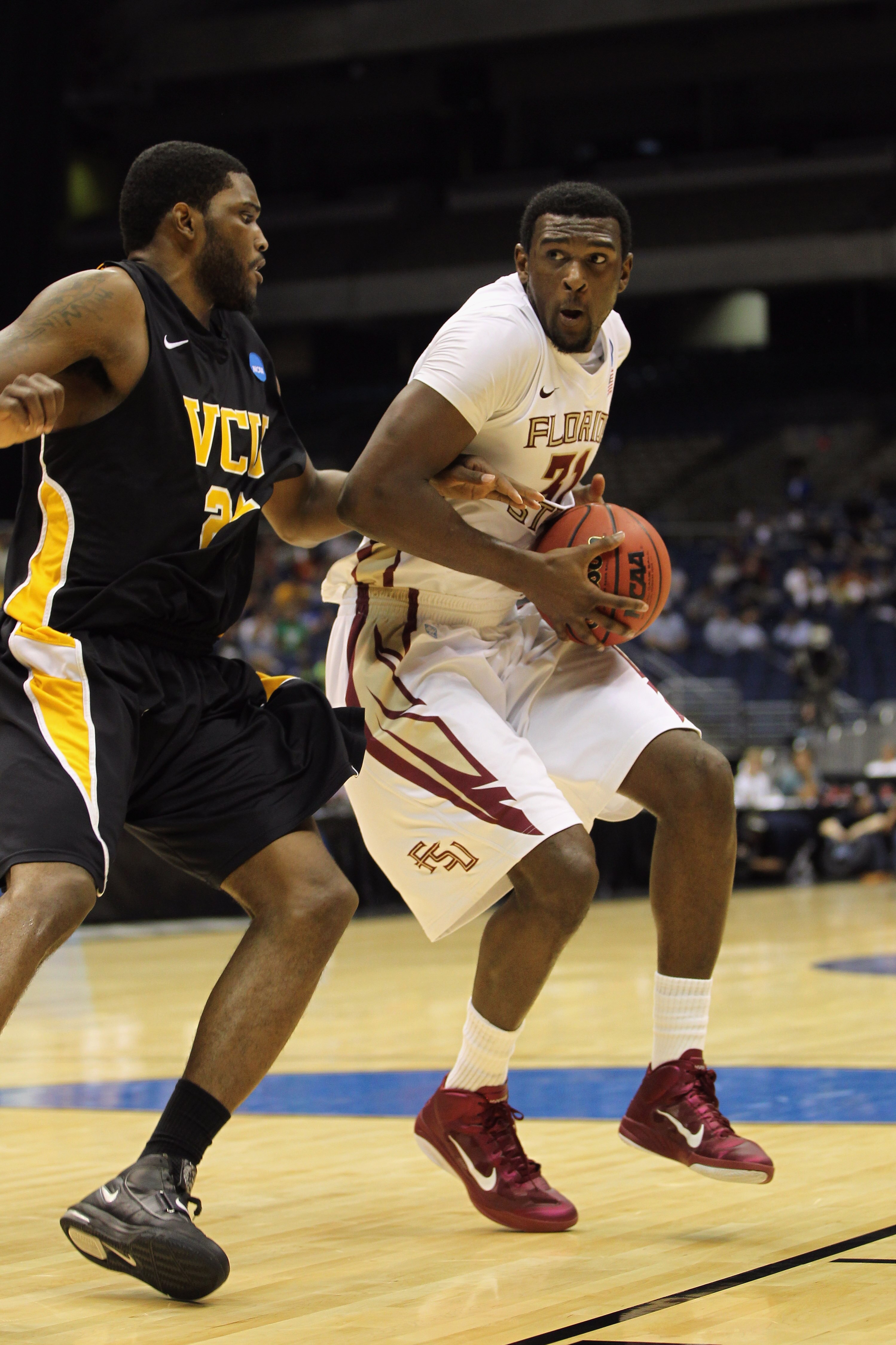 SAN ANTONIO, TX - MARCH 25:  Chris Singleton #31 of the Florida State Seminoles handles the ball against Jamie Skeen #21 of the Virginia Commonwealth Rams during the southwest regional of the 2011 NCAA men's basketball tournament at the Alamodome on March