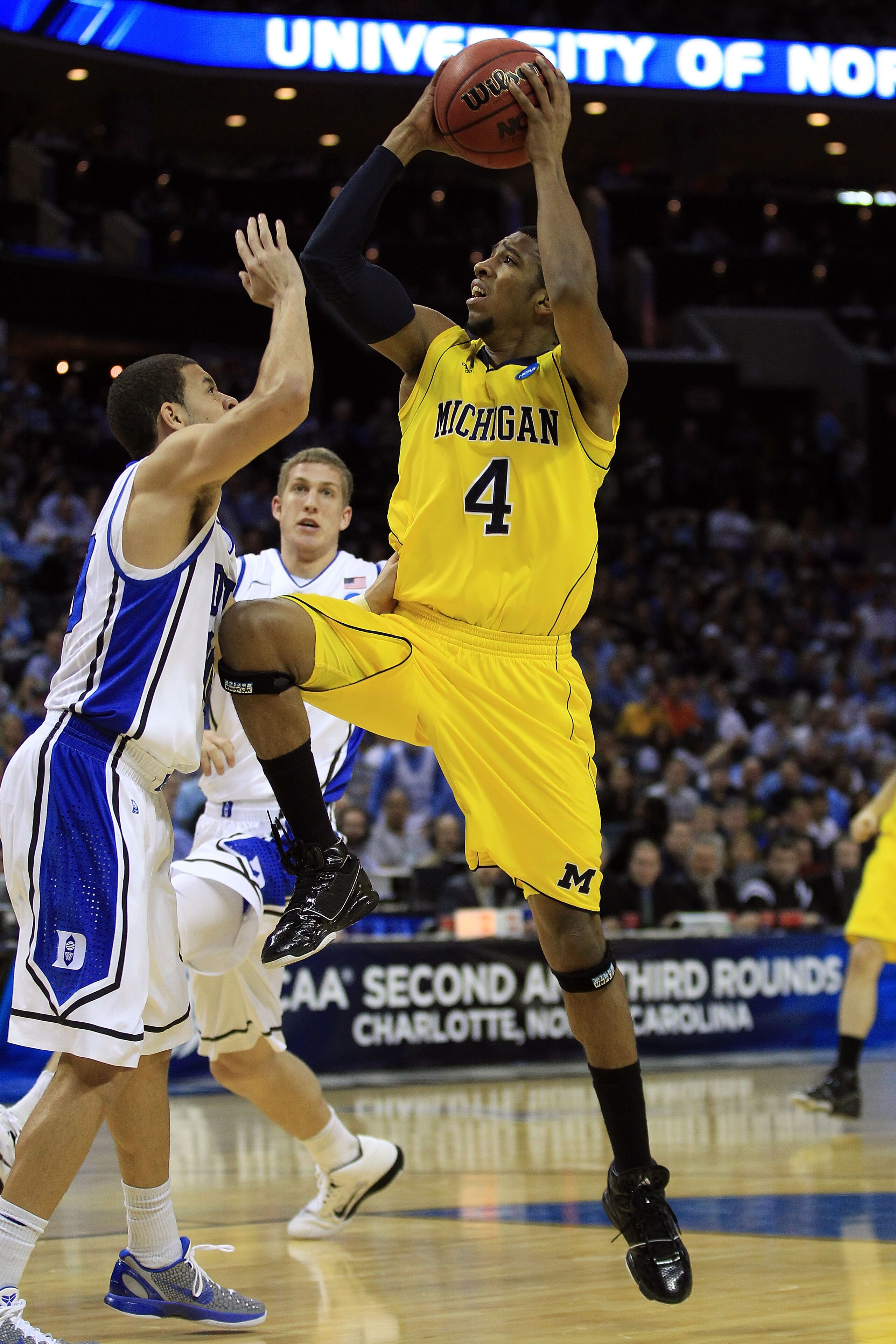 CHARLOTTE, NC - MARCH 20:  Darius Morris #4 of the Michigan Wolverines goes up for a shot against Seth Curry #30 of the Duke Blue Devils during the third round of the 2011 NCAA men's basketball tournament at Time Warner Cable Arena on March 20, 2011 in Ch