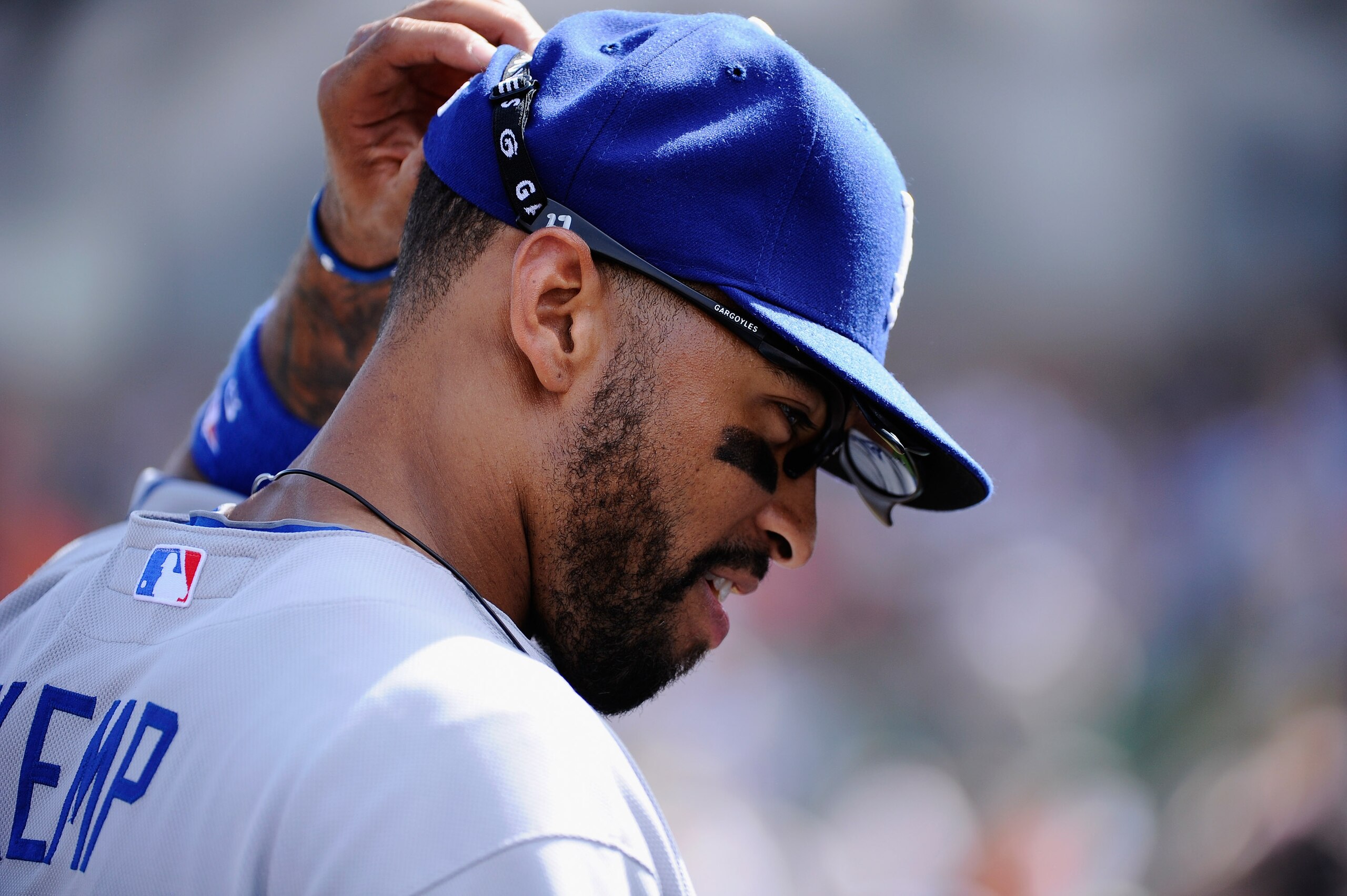 SCOTTSDALE, AZ - MARCH 18:  Matt Kemp #27 of the Los Angeles Dodgers takes off his baseball cap and glasses after misplaying a fly ball hit by Mike Fontenot #14 of the San Francisco Giants that scored two runs during the fifth inning of the baseball game