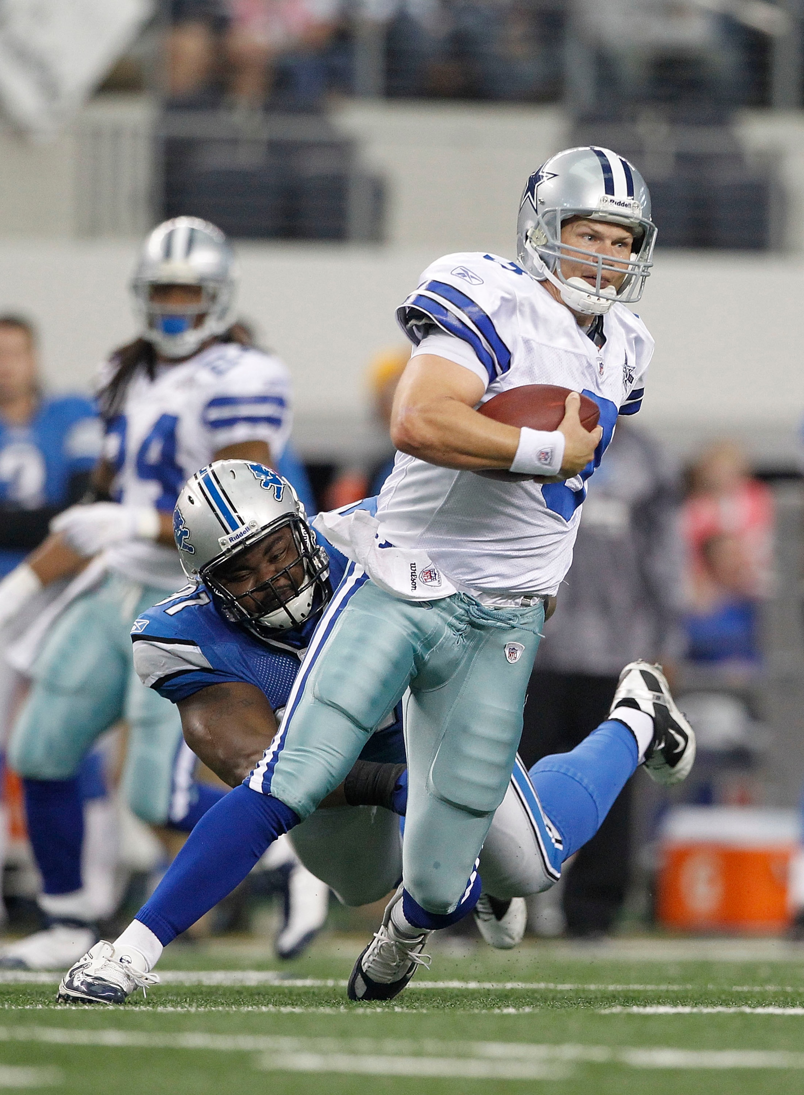 ARLINGTON, TX - NOVEMBER 21:  Jon Kitna #3 of the Dallas Cowboys breaks the tackle of Andre Fluellen #96 of the Detroit Lions and runs 29 yards for a fourth quarter touchdown at Dallas Stadium on November 21, 2010 in Arlington, Texas. The Cowboys defeated