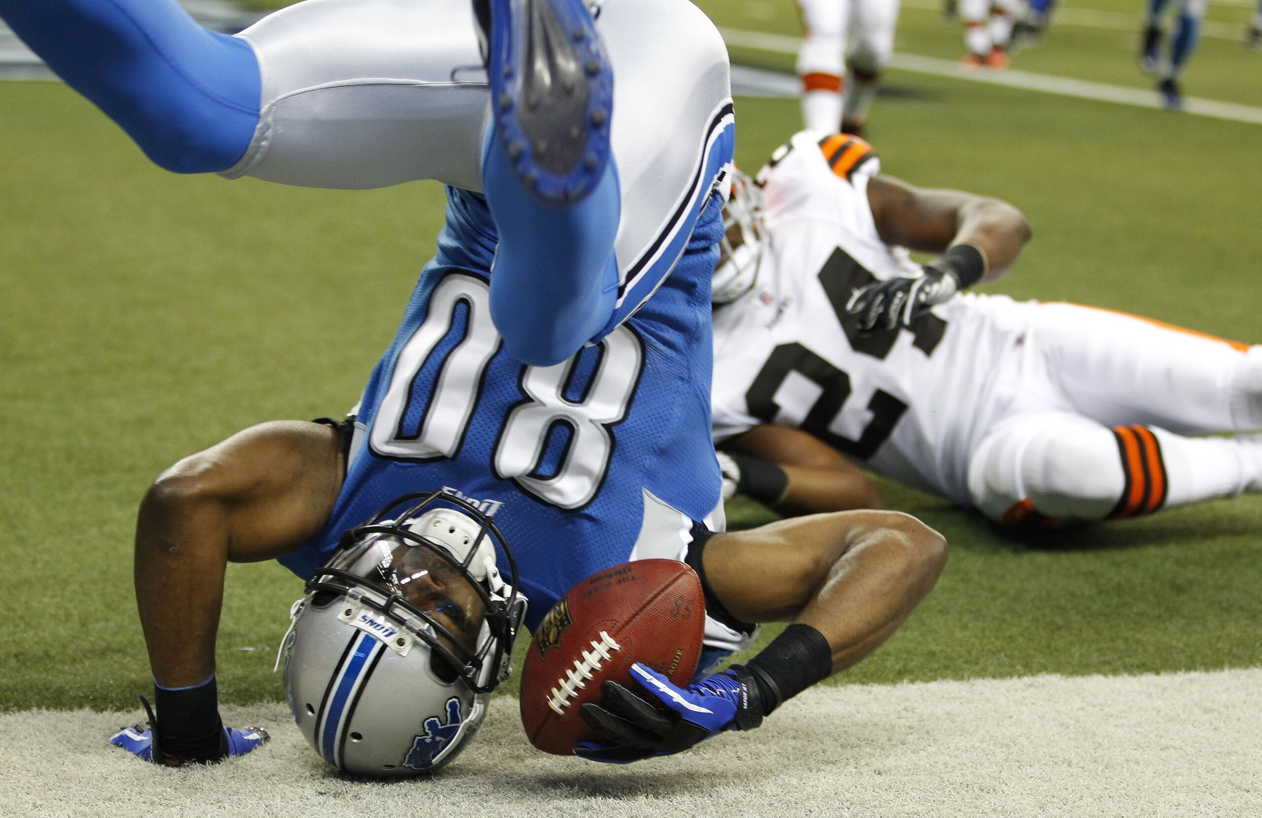 DETROIT - AUGUST 28:  Bryant Johnson #80 of the Detroit Lions scores a first quarter touchdown behind Sheldon Brown #24 of the Cleveland Browns during a preseason game on August 28, 2010 at Ford Field in Detroit, Michigan.  (Photo by Gregory Shamus/Getty