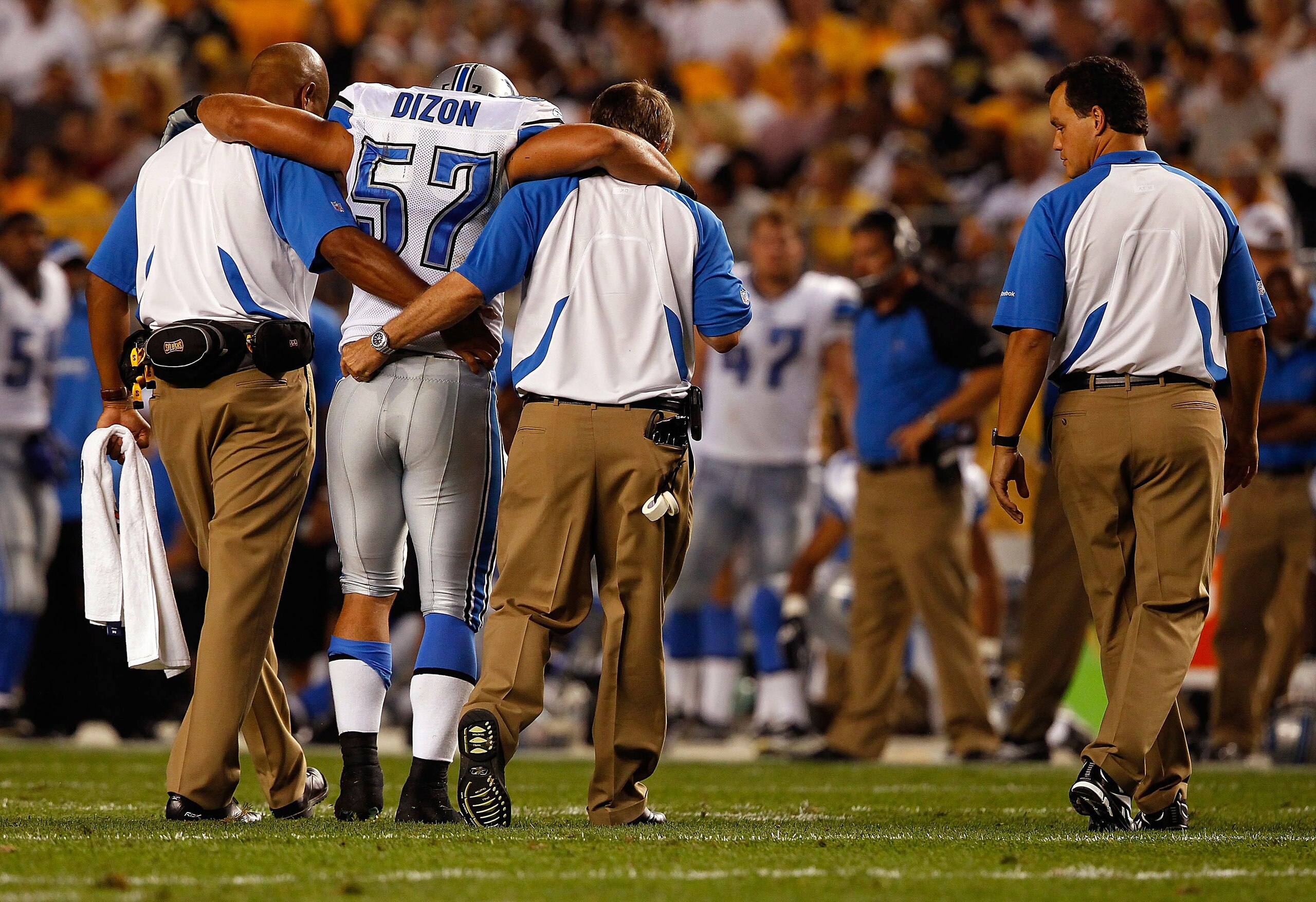 PITTSBURGH - AUGUST 14:  Jordon Dizon #57 of the Detroit Lions walks off the field with the help of trainers after injuring himself during the preseason game against the Pittsburgh Steelers on August 14, 2010 at Heinz Field in Pittsburgh, Pennsylvania.  (