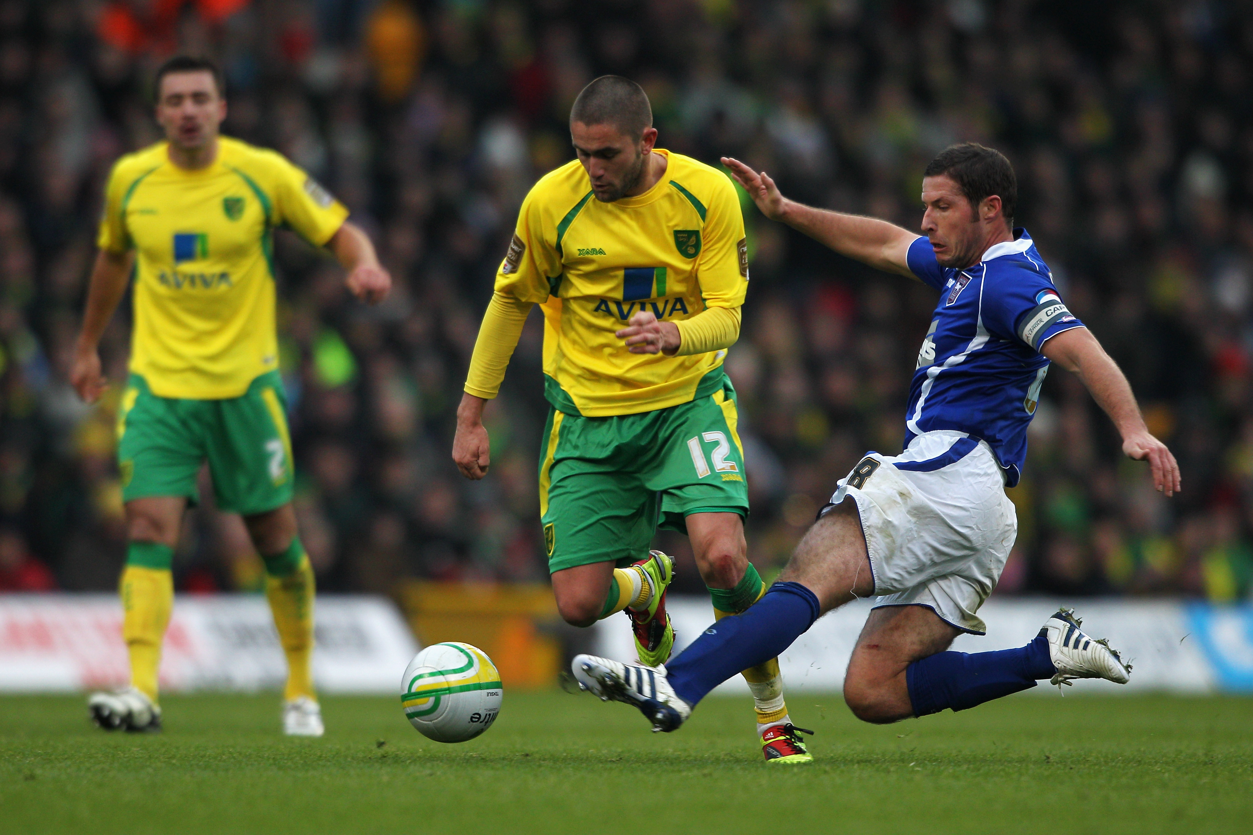 NORWICH, ENGLAND - NOVEMBER 28:  Henri Lansbury of Norwich is tackled and fouled by David Norris of Ipswich during the npower Championship match between Norwich City and Ipswich Town at Carrow Road on November 28, 2010 in Norwich, England.  (Photo by Dean