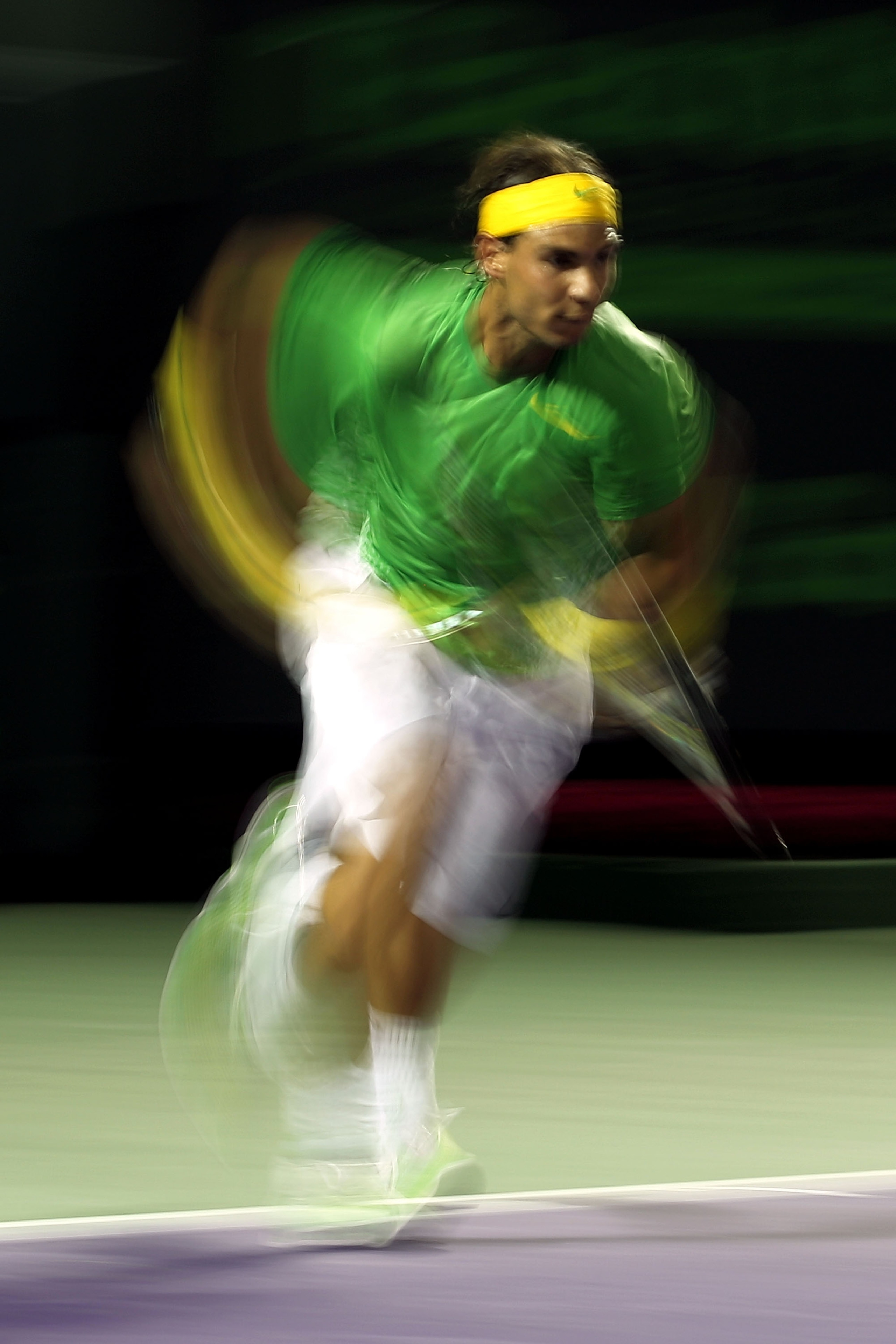 KEY BISCAYNE, FL - MARCH 26:  Rafael Nadal of Spain runs towards the net against Kei Nishikori of Japan during the Sony Ericsson Open at Crandon Park Tennis Center on March 26, 2011 in Key Biscayne, Florida.  (Photo by Al Bello/Getty Images)