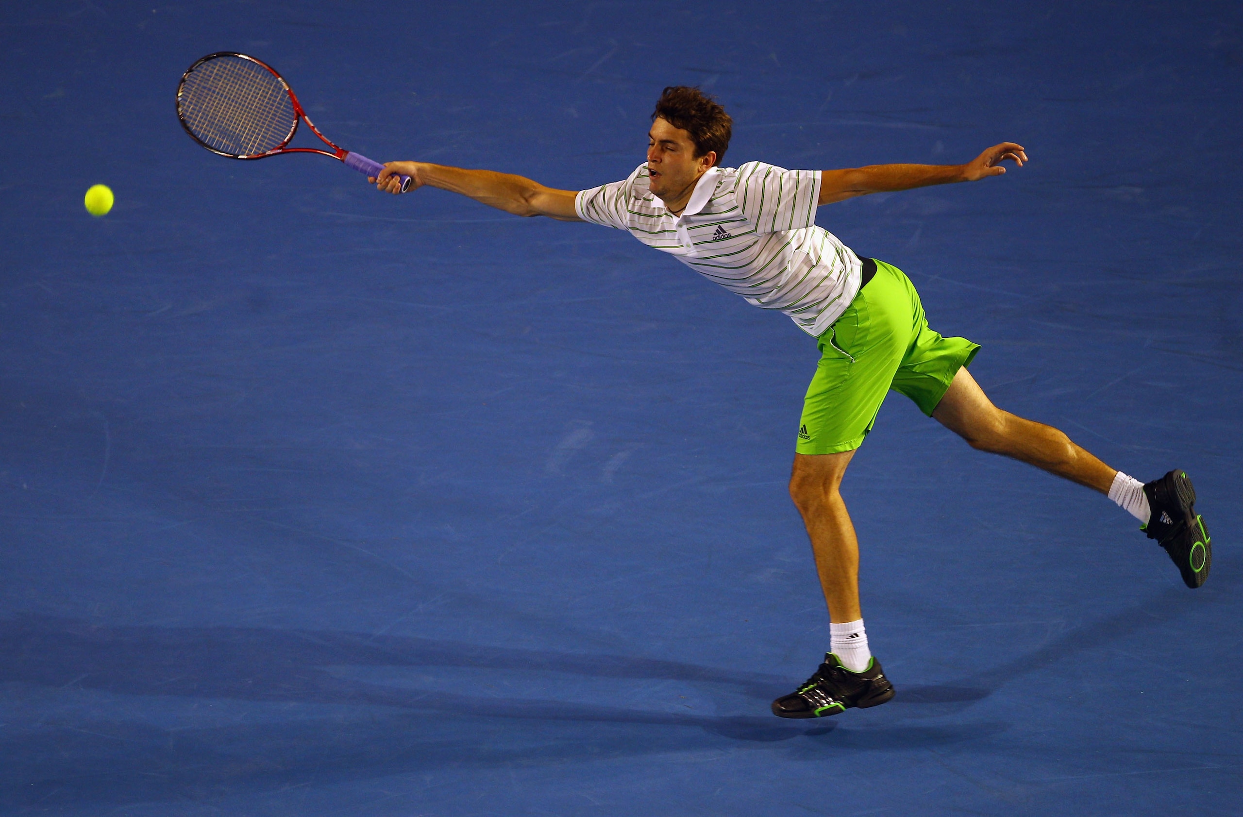 MELBOURNE, AUSTRALIA - JANUARY 19:  Gilles Simon of France plays a forehand in his second round match against Roger Federer of Switzerland during day three of the 2011 Australian Open at Melbourne Park on January 19, 2011 in Melbourne, Australia.  (Photo