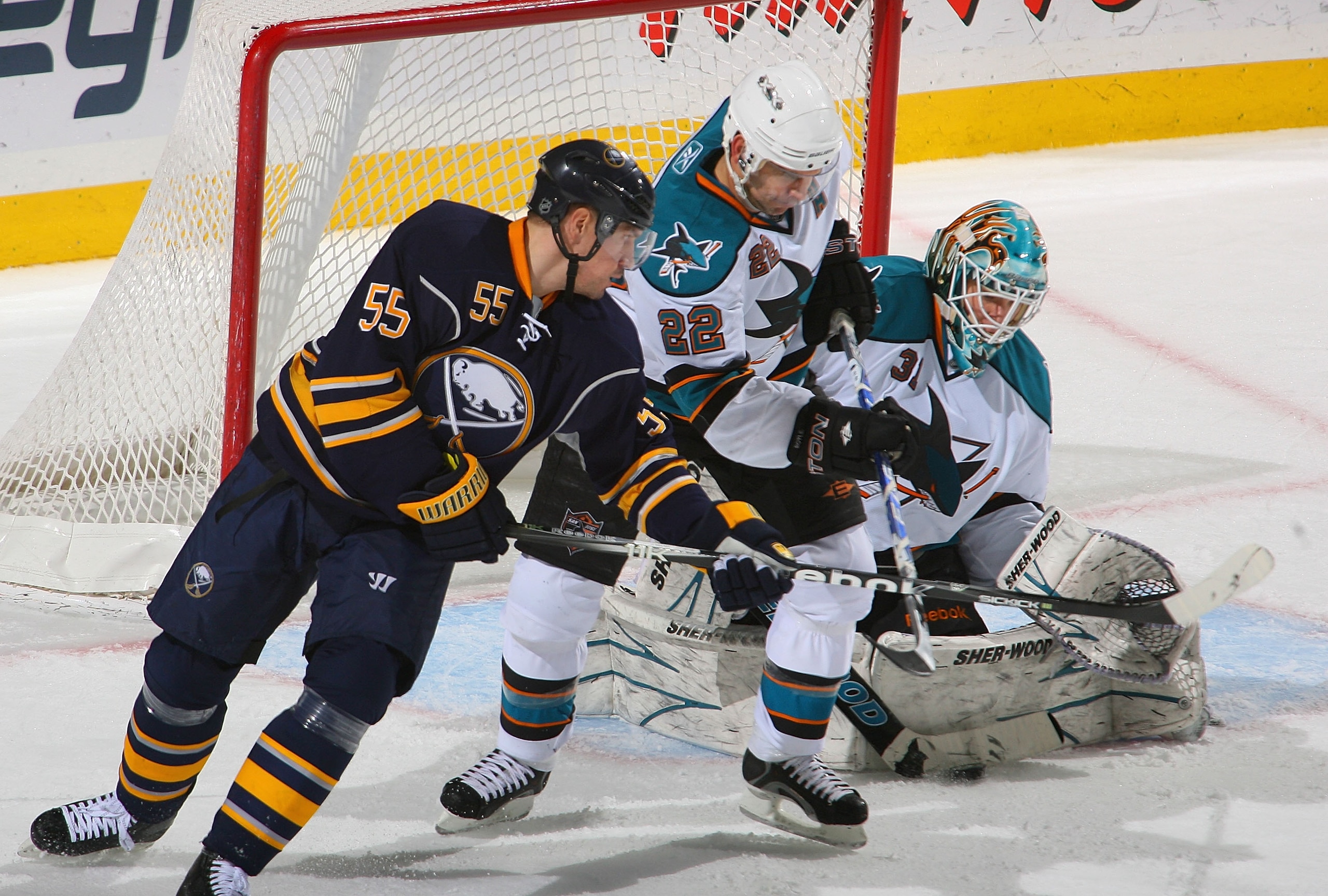 BUFFALO, NY - DECEMBER 09: Antti Niemi #31 of the San Jose Sharks makes a save and Dan Boyle #22 of the Sharks defends against Jochen Hecht #55 of the Buffalo Sabres at HSBC Arena on December 9, 2010 in Buffalo, New York.  (Photo by Rick Stewart/Getty Ima