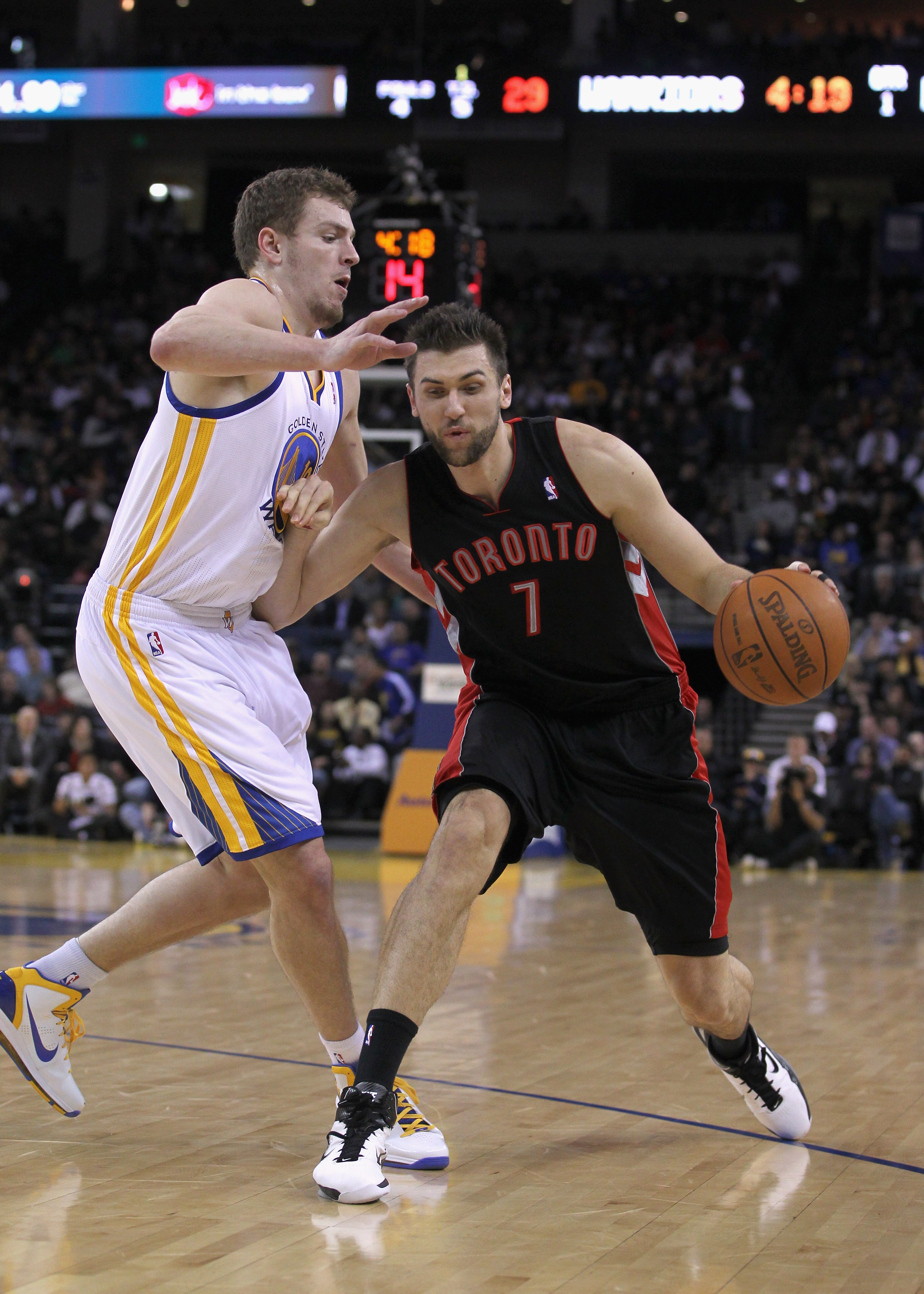 OAKLAND, CA - MARCH 25: Andrea Bargnani #7 of the Toronto Raptors drives on David Lee #10 of the Golden State Warriors at Oracle Arena on March 25, 2011 in Oakland, California. NOTE TO USER: User expressly acknowledges and agrees that, by downloading and