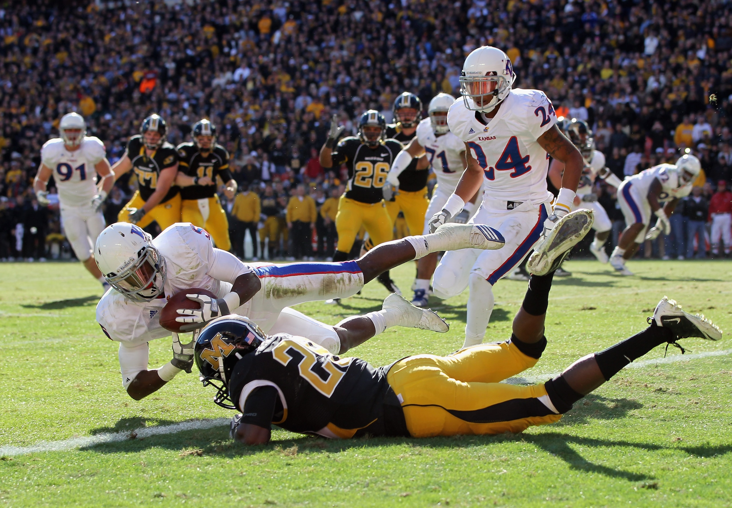 KANSAS CITY, MO - NOVEMBER 27:  Cornerback Greg Brown #5 of the Kansas Jayhawks intercepts a pass intended for Jerrell Jackson #29 of the Missouri Tigers on the one-yard-line during the first half of the game on November 27, 2010 at Arrowhead Stadium in K