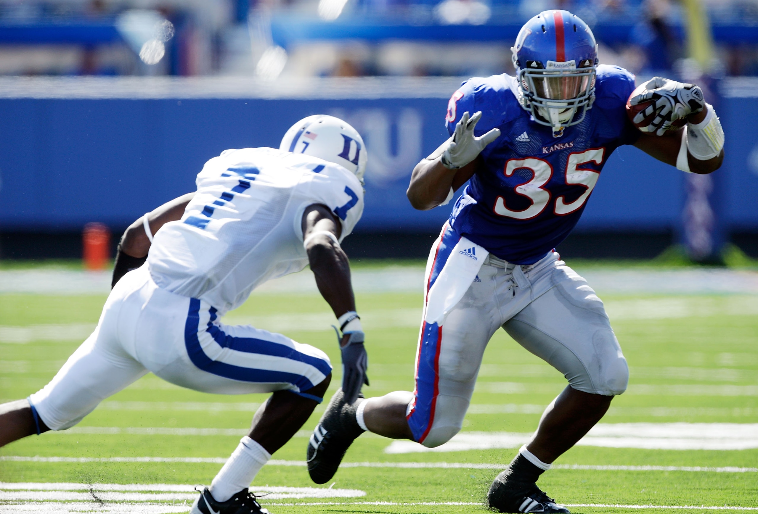 LAWRENCE, KS - SEPTEMBER 19:  Corrigan Powell #35 of the Kansas Jayhawks carries the ball as Leon Wright #7 of the Duke Blue Devils defends during the game at Kivisto Field at Memorial Stadium on September 19, 2009 in Lawrence, Kansas.  (Photo by Jamie Sq