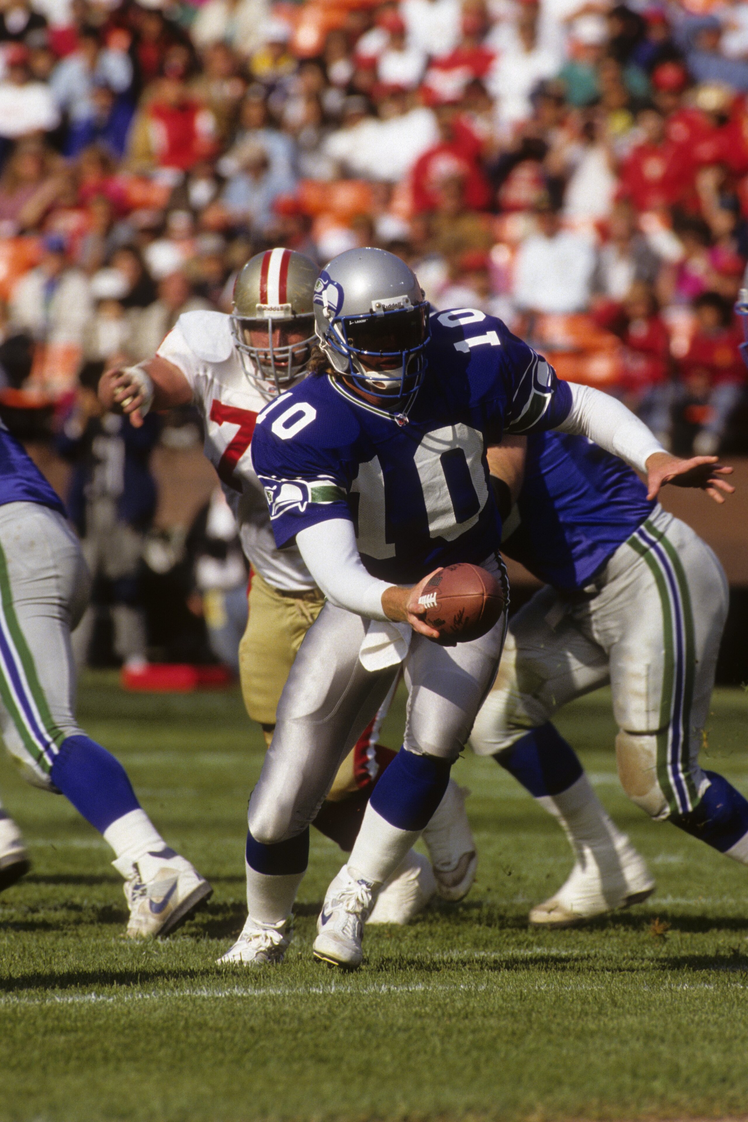 SAN FRANCISCO, CA - AUGUST 28:  Quarterback Dan McGwire #10 of the Seattle Seahawks looks to hand off the ball during the exhibition game against the San Francisco 49ers at Candlestick Park on August 28, 1992 in San Francisco, California.  The 49ers won 2