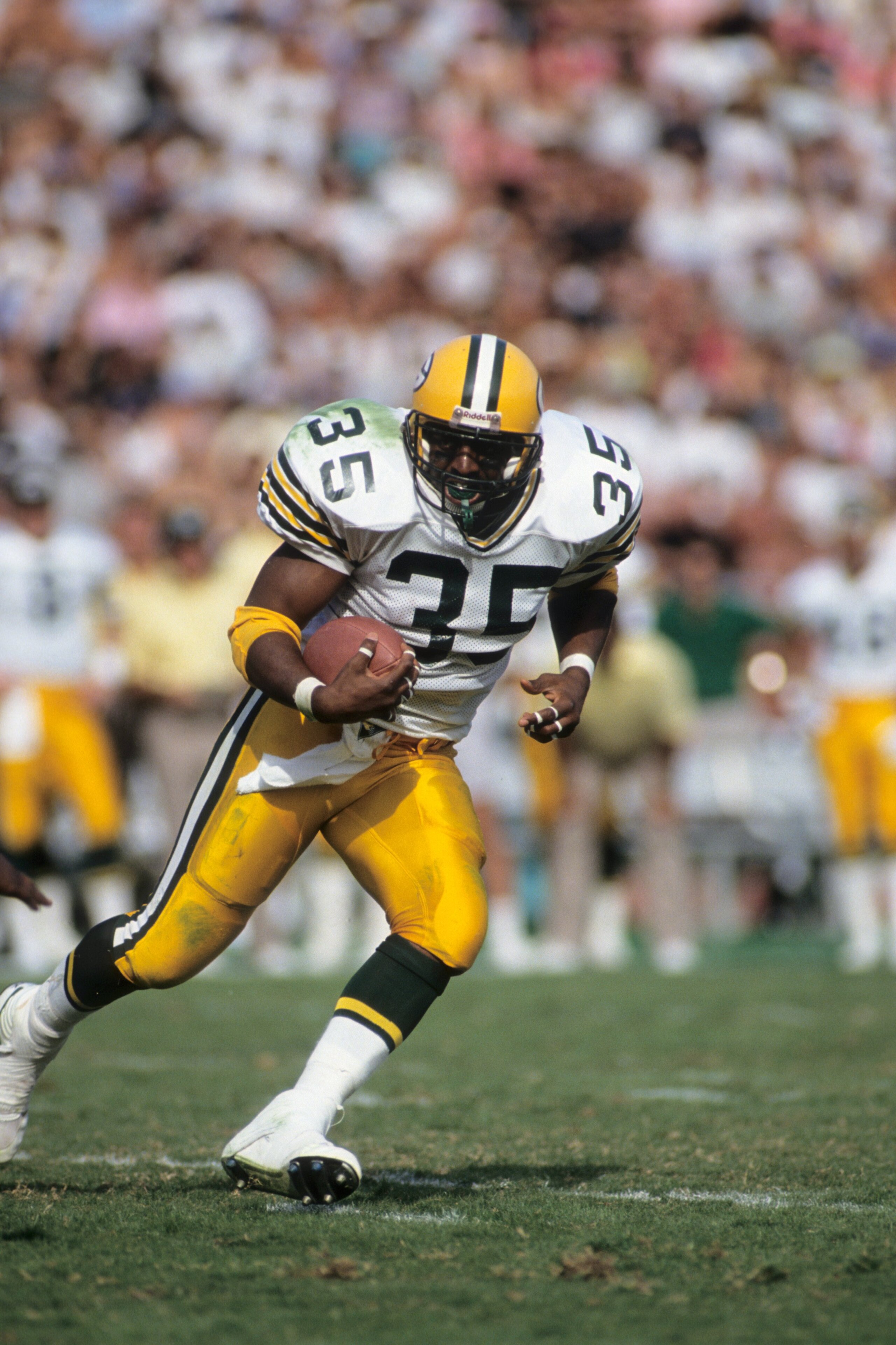 LOS ANGELES, CA - NOVEMBER 11:  Fullback Michael Haddix #35 of the Green Bay Packers runs the ball against the Los Angeles Raiders during a game at the Los Angeles Memorial Coliseum on November 11, 1990 in Los Angeles, California.  The Packers won 29-16  