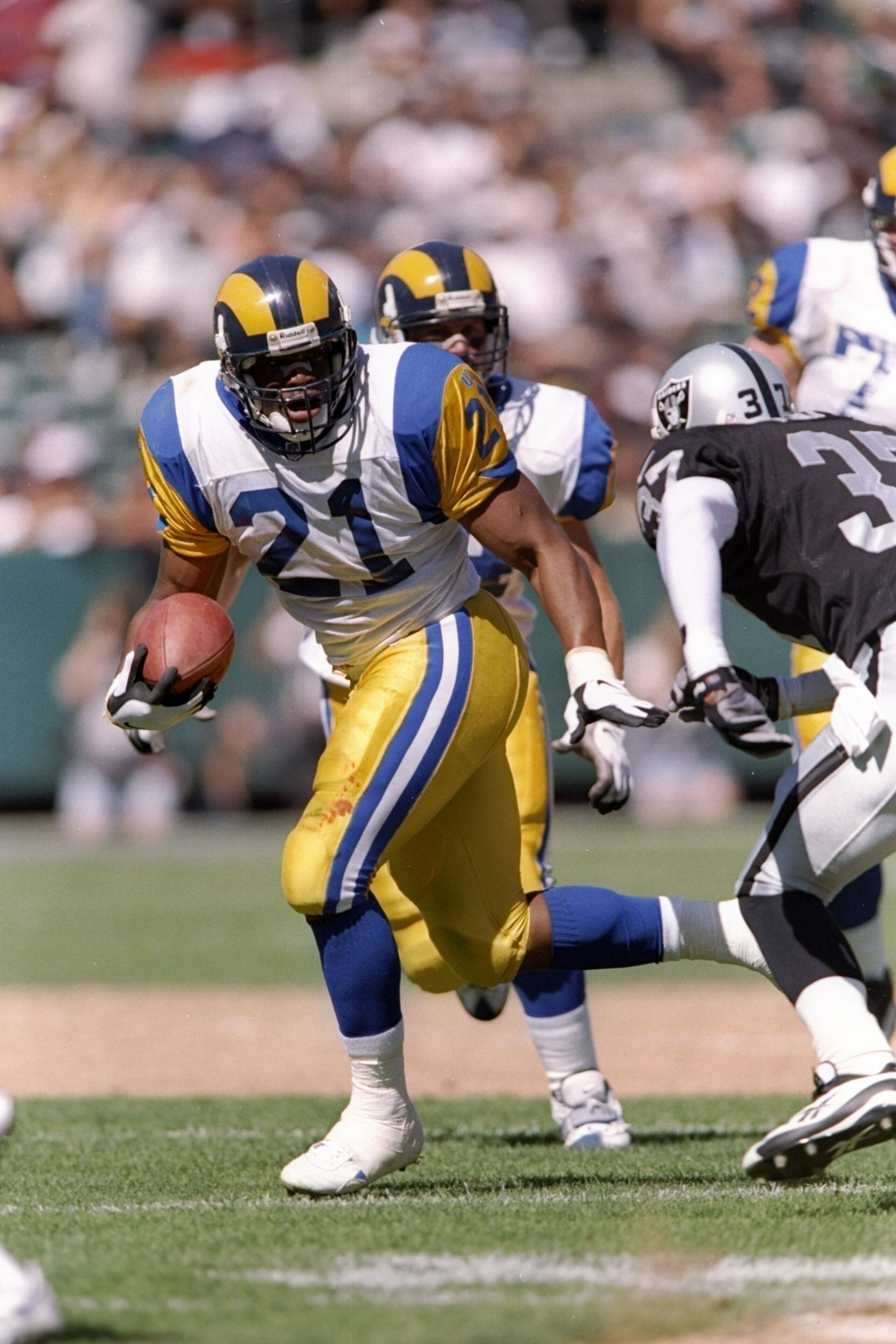 28 Sep 1997:  Running back Lawrence Phillips #21 of the St. Louis Rams carries the football during the Rams 35-17 loss to the Oakland Raiders at UMAX Stadium in Oakland, California. Mandatory Credit: Todd Warshaw  /Allsport