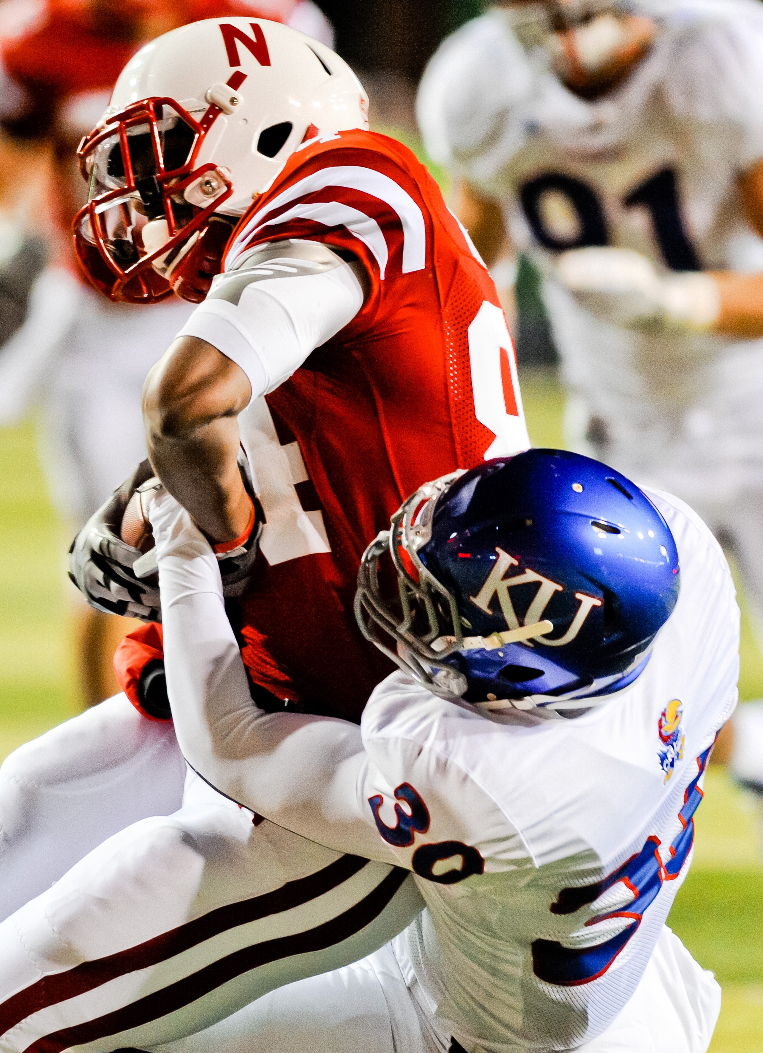 LINCOLN, NE - NOVEMBER 13: Brandon Kinnie #84 of the Nebraska Cornhuskers finishes of a reception against Anthony Davis #30 of the Kansas Jayhawks during their game at Memorial Stadium on November 13, 2010 in Lincoln, Nebraska. Nebraska Defeated Kansas 20