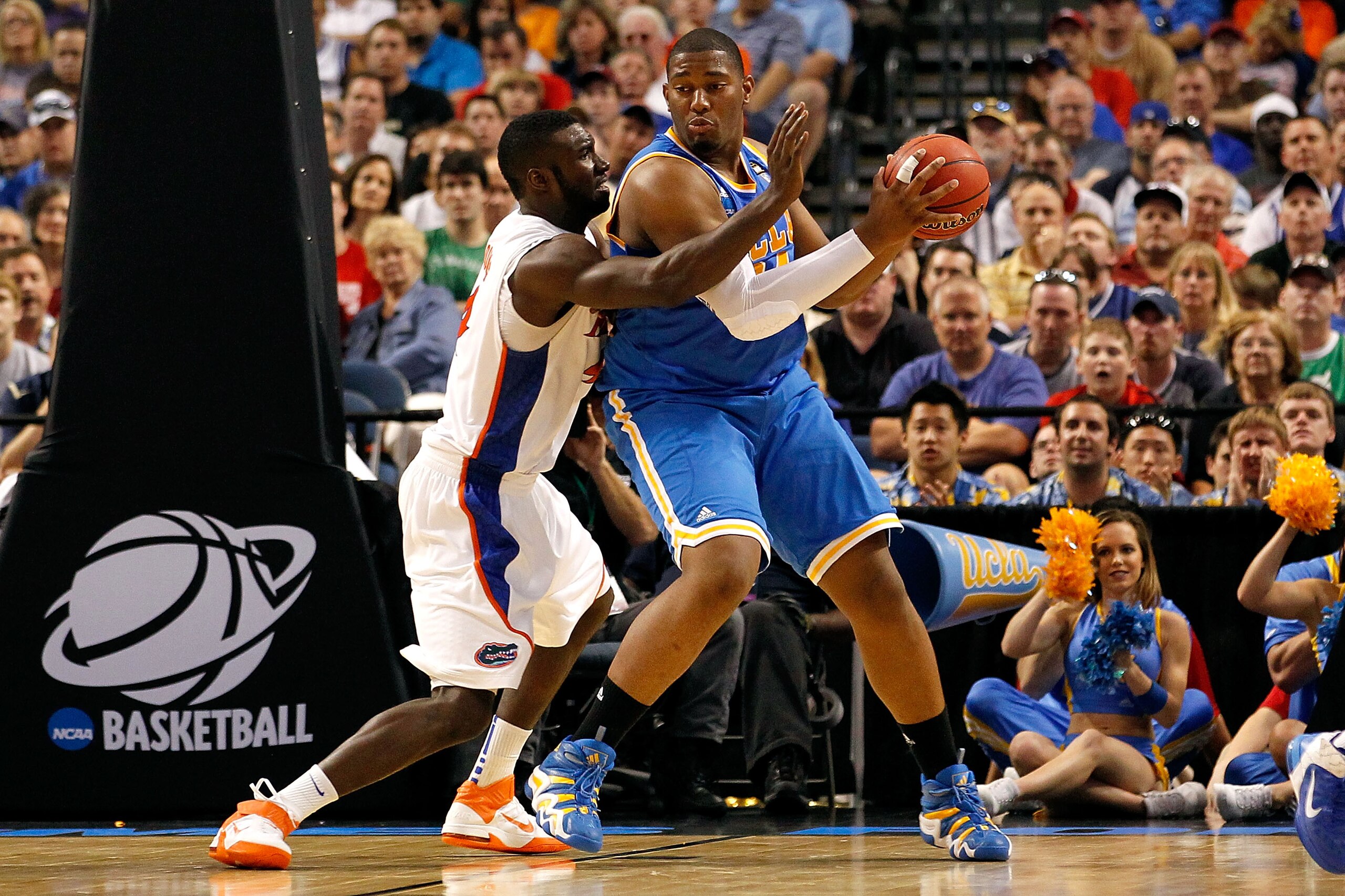 TAMPA, FL - MARCH 19:  Joshua Smith #34 of the UCLA Bruins posts up against Patric Young #4 of the Florida Gators during the third round of the 2011 NCAA men's basketball tournament at St. Pete Times Forum on March 19, 2011 in Tampa, Florida. Florida won