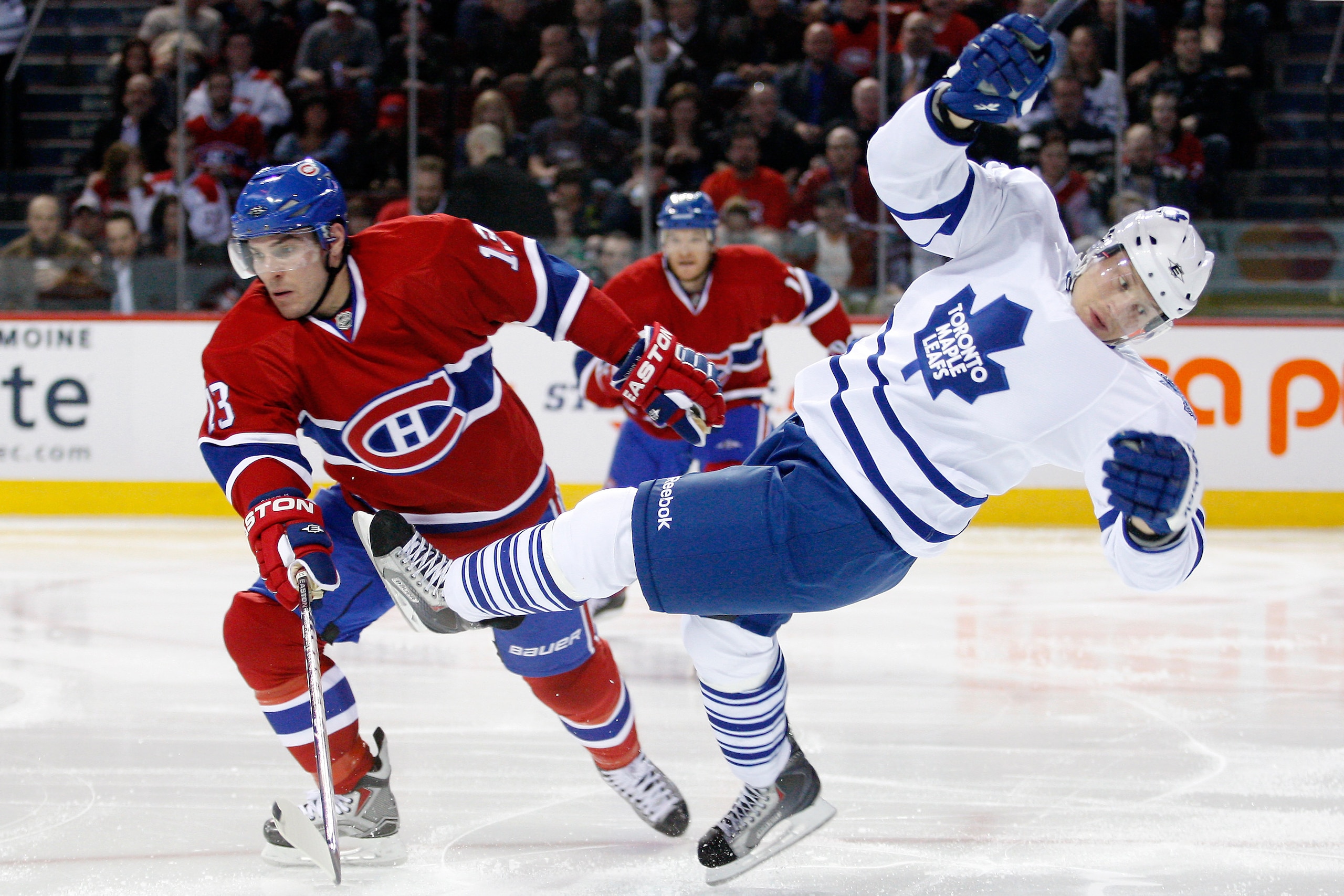 MONTREAL, CANADA - FEBRUARY 24:  Mike Cammalleri #13 of the Montreal Canadiens hauls down Mikhail Grabovski #84 of the Toronto Maple Leafs to the ice during the NHL game at the Bell Centre on February 24, 2011 in Montreal, Quebec, Canada.  The Maple Leafs