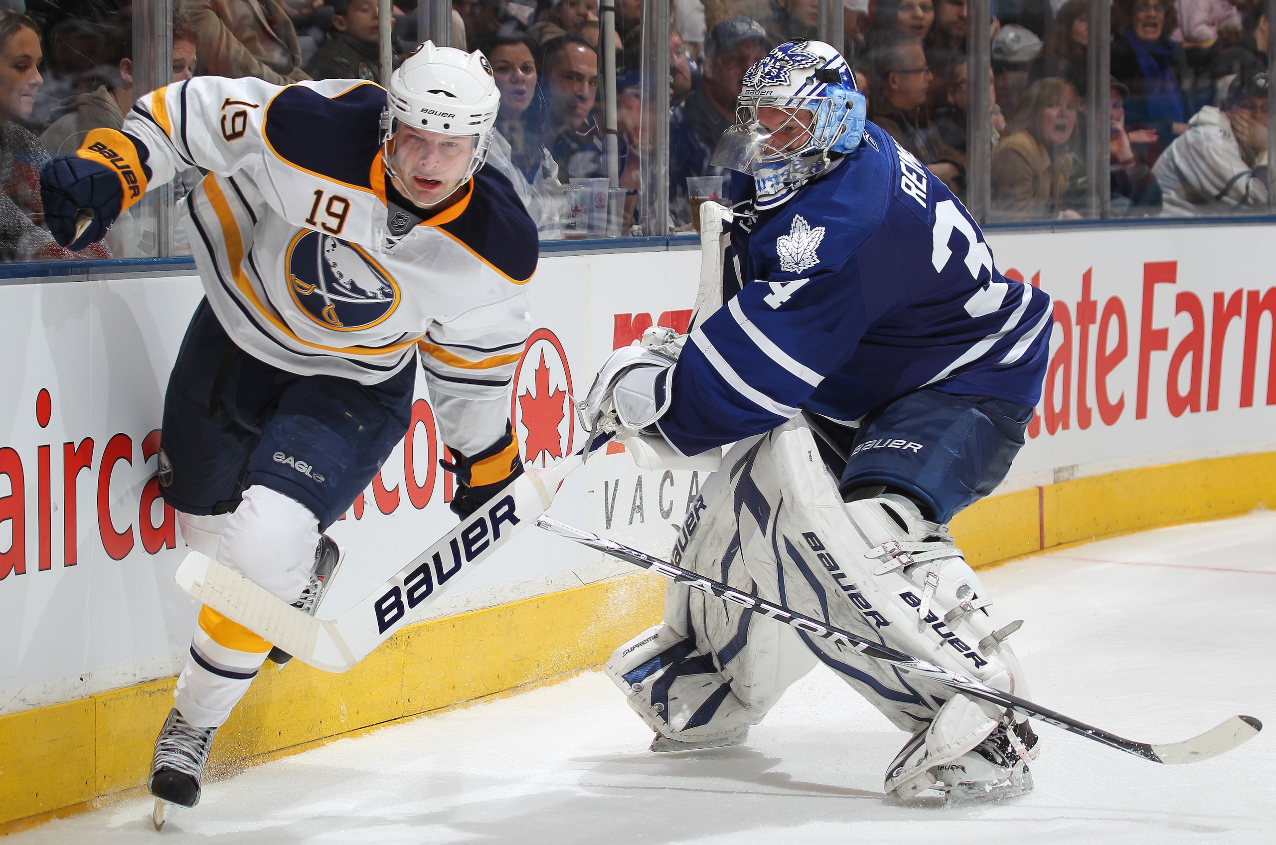 TORONTO, CANADA - MARCH 12:  Tim Connolly #19 of the Buffalo Sabres is held up by James Reimer #34 of the Toronto Maple Leafs in a game on March 12, 2011 at the Air Canada Centre in Toronto, Canada. The Leafs defeated the Sabres 4-3. (Photo by Claus Ander