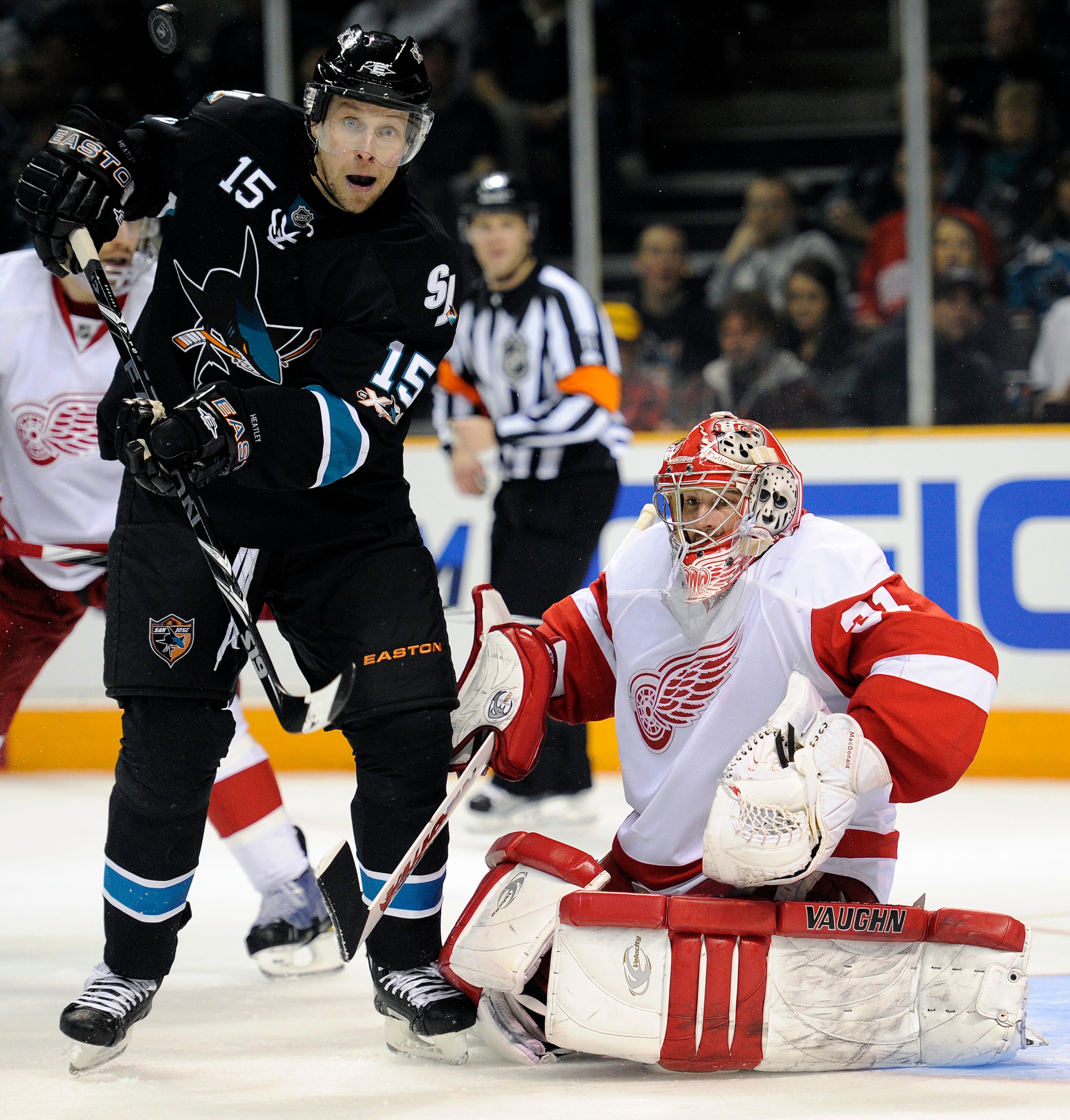SAN JOSE, CA - MARCH 3: Dany Heatley #15 of the San Jose Sharks deflects the puck in front of goalie Joey MacDonald #31 of the Detroit Red Wings in the second period of an NHL hockey game at the HP Pavilion on March 3, 2011 in San Jose, California. The Sh