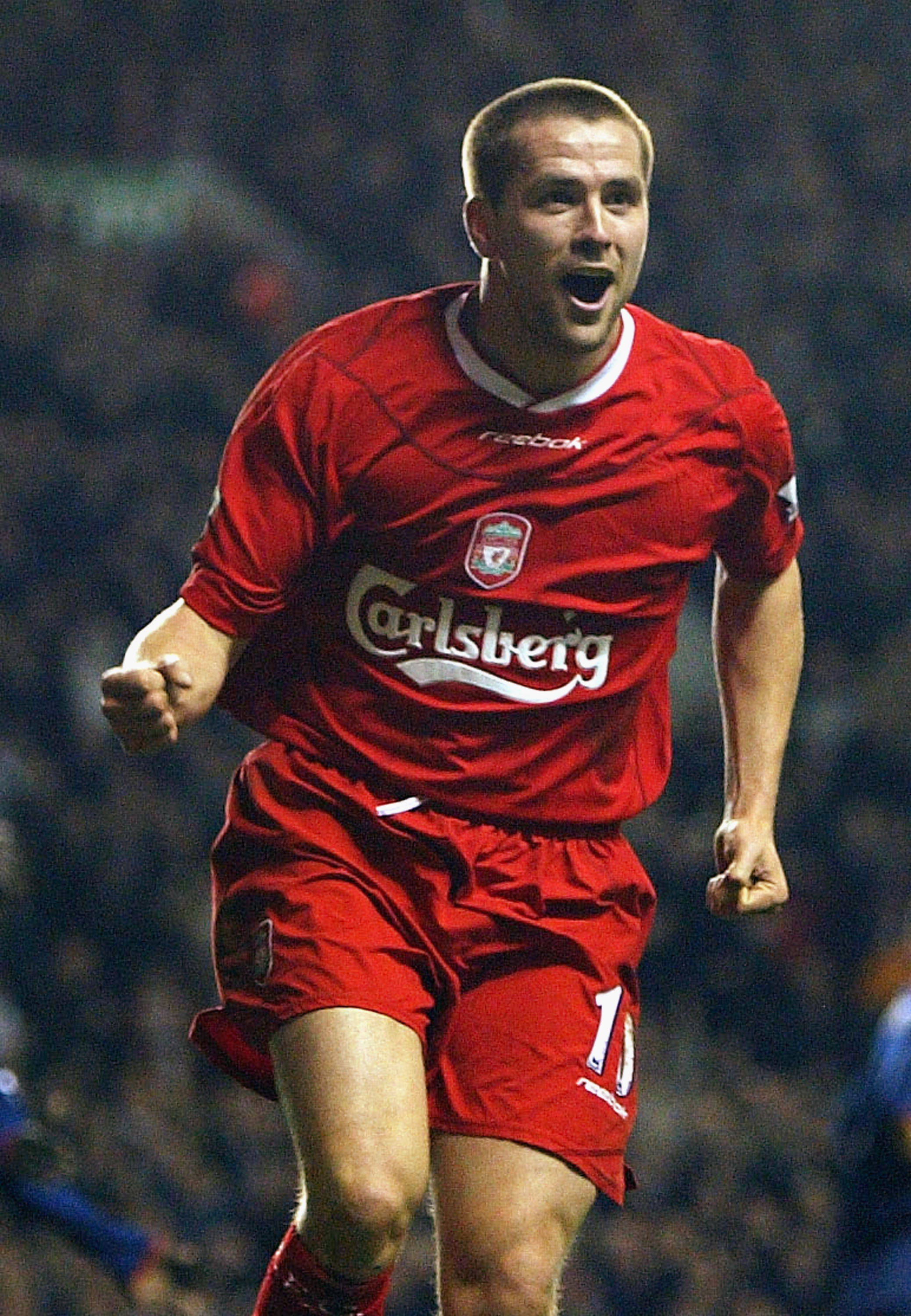 LIVERPOOL, ENGLAND - MARCH 17:  Michael Owen of Liverpool celebrates scoring his second goal during the FA Barclaycard Premiership match between Liverpool and Portsmouth at Anfield on March 17, 2004 in Liverpool, England.  (Photo by Bryn Lennon/Getty Imag