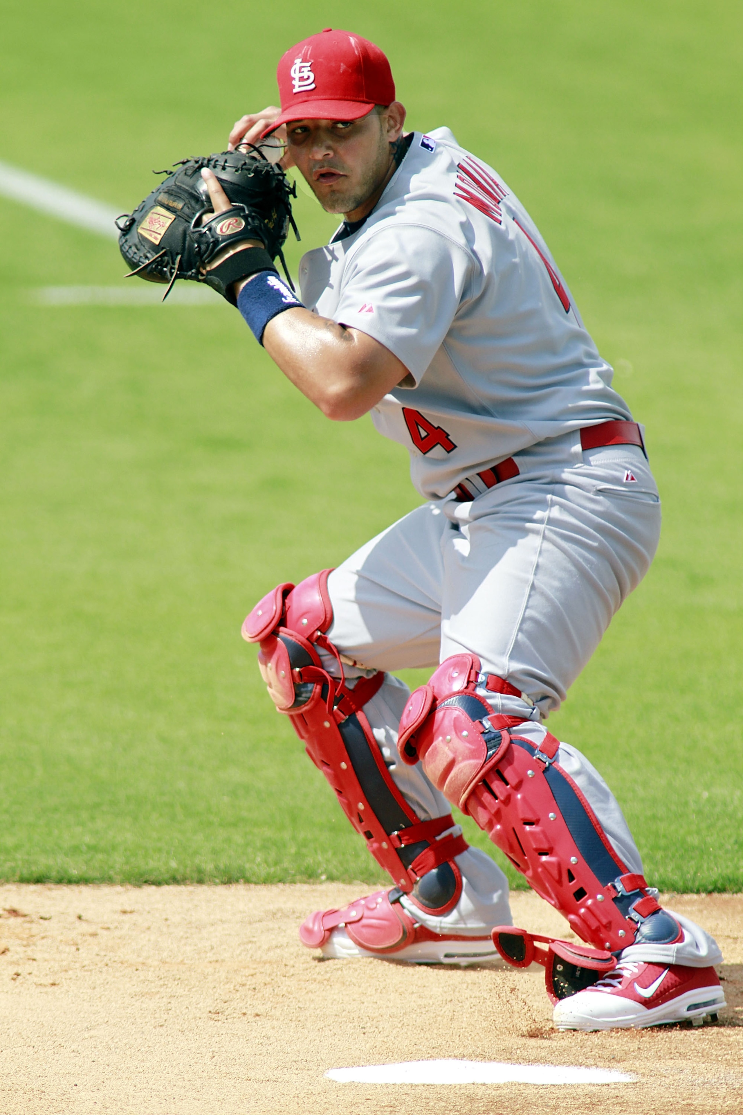 JUPITER, FL - MARCH 01:  Catcher Yadier Molina of the St. Louis Cardinals prepares for the Florida Marlins at Roger Dean Stadium on March 1, 2011 in Jupiter, Florida.  (Photo by Marc Serota/Getty Images)