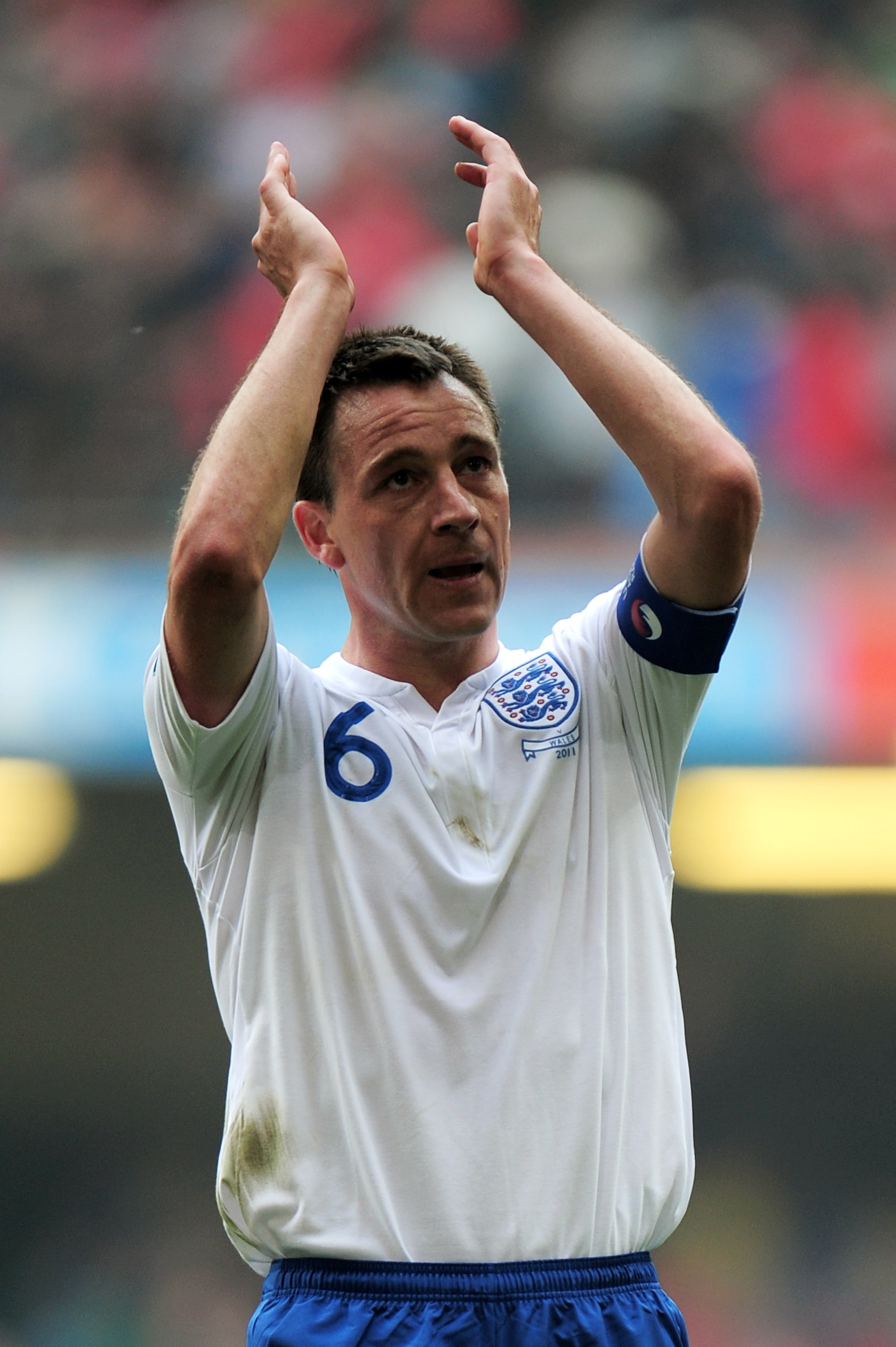 CARDIFF, WALES - MARCH 26:  England captain John Terry applauds the travelling fans following his team's 2-0 victory during the UEFA EURO 2012 Group G qualifying match between Wales and England at the Millennium Stadium on March 26, 2011 in Cardiff, Wales