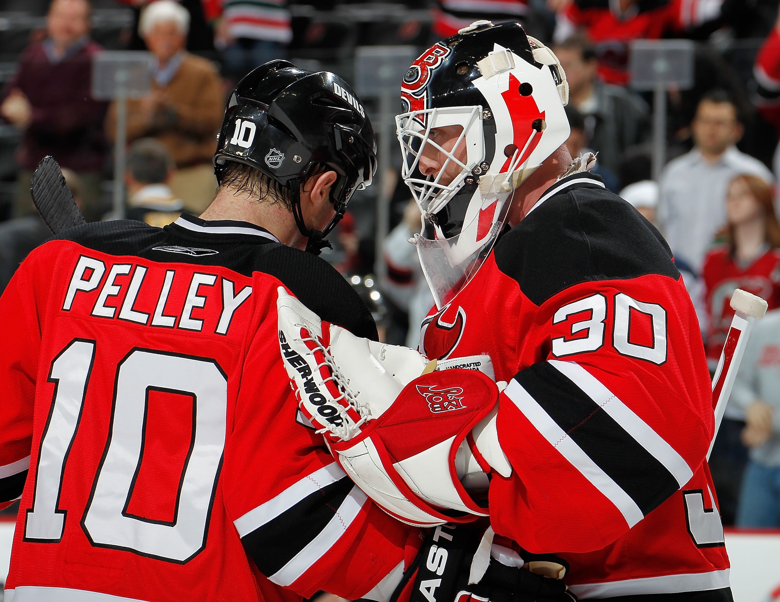 NEWARK, NJ - JANUARY 20:  Goalie Martin Brodeur #30 of the New Jersey Devils is congratulated on his shutout win after an NHL hockey game against the Pittsburgh Penguins at the Prudential Center on January 20, 2011 in Newark, New Jersey.  (Photo by Paul B