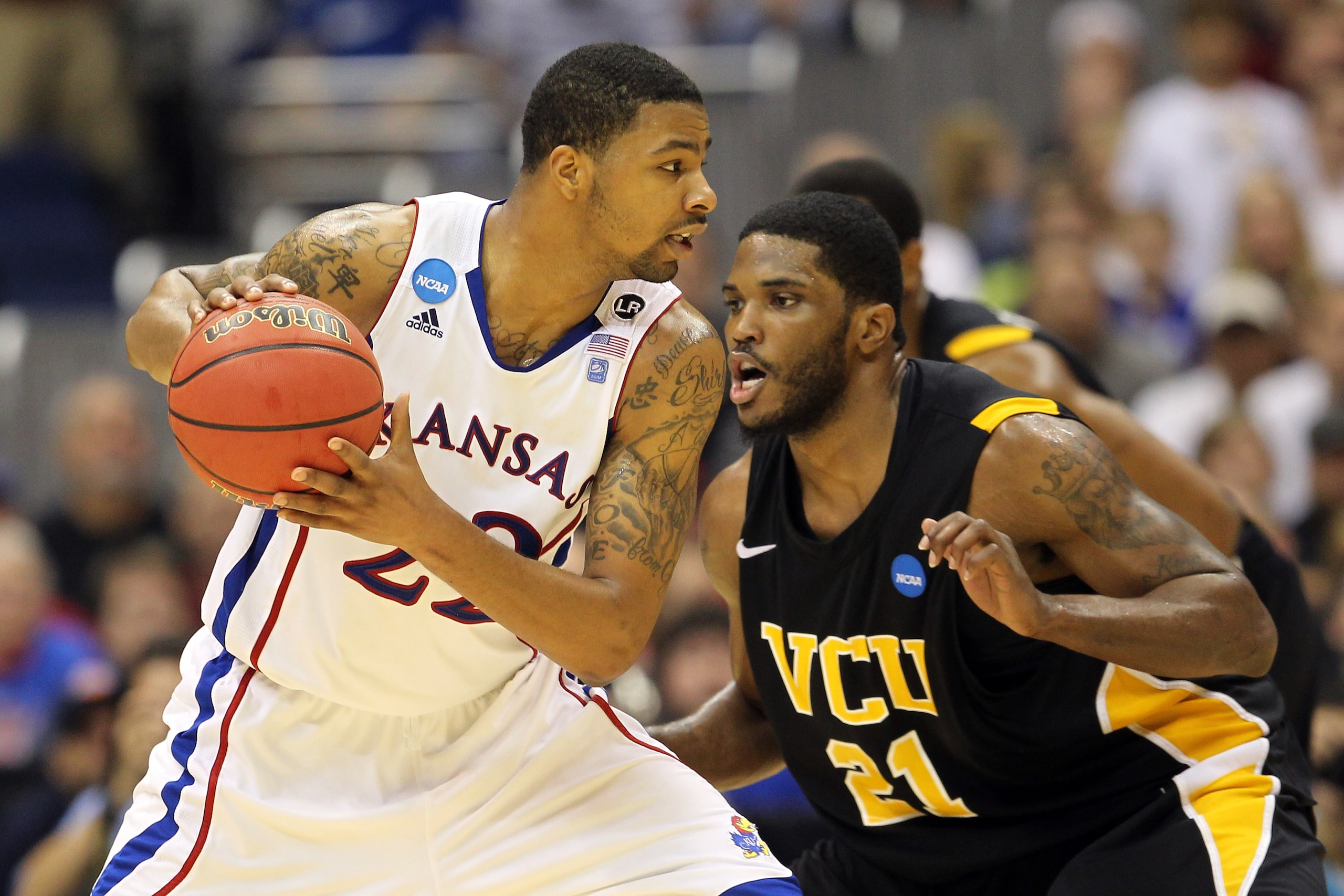 SAN ANTONIO, TX - MARCH 27: Marcus Morris #22 of the Kansas Jayhawks handles the ball against Jamie Skeen #21 of the Virginia Commonwealth Rams during the southwest regional final of the 2011 NCAA men's basketball tournament at the Alamodome on March 27, SAN ANTONIO, TX - MARCH 27: Marcus Morris #22 of the Kansas Jayhawks handles the ball against Jamie Skeen #21 of the Virginia Commonwealth Rams during the southwest regional final of the 2011 NCAA men's basketball tournament at the Alamodome on March 27,