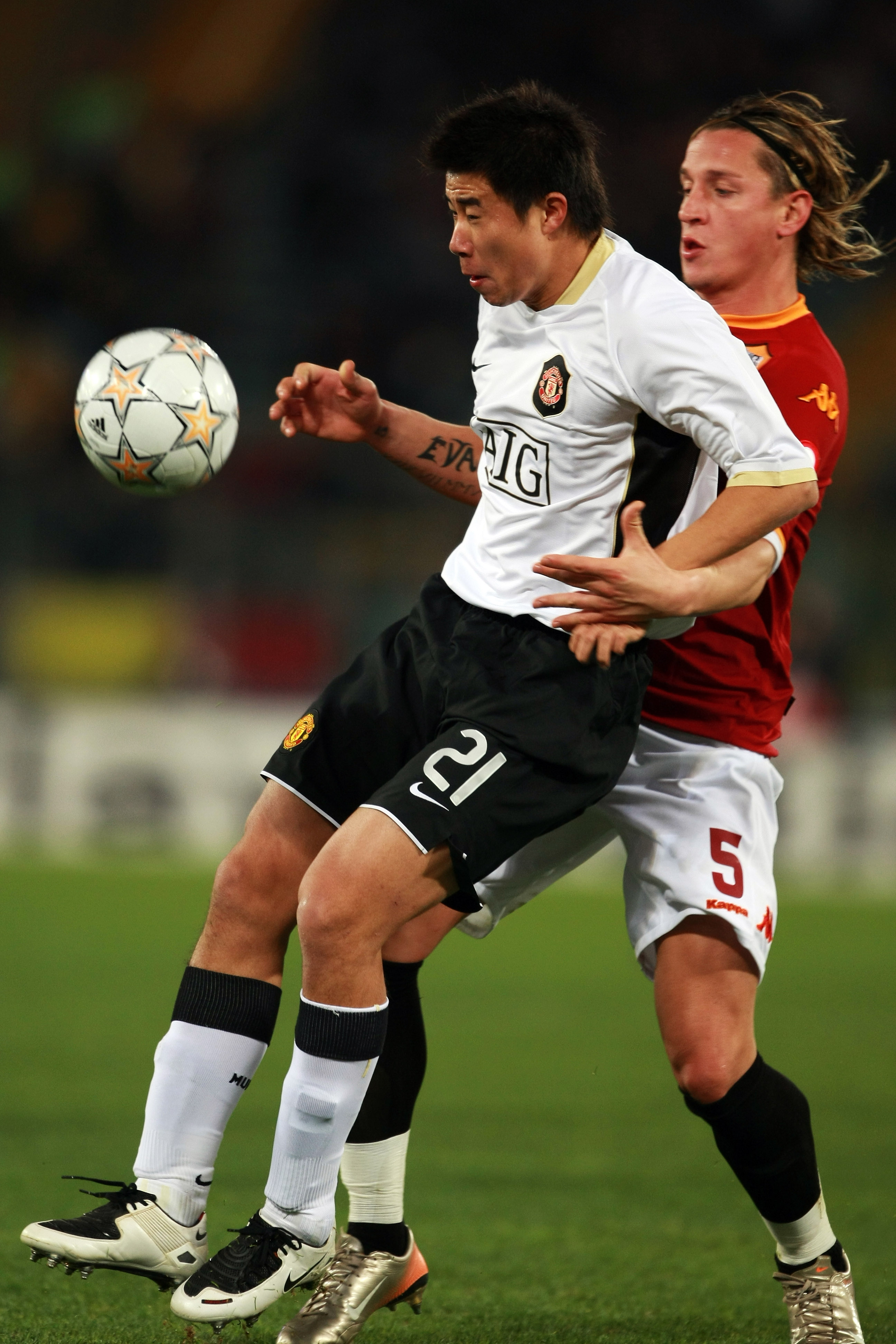 ROME - DECEMBER 12:  Fangzhuo Dong (L) of Manchester United and Philippe Mexes (R) of Roma battle for the ball during the UEFA Champions League match between AS Roma and Manchester United at the Olympic Stadium on December 12, 2007, in Rome, Italy.  (Phot