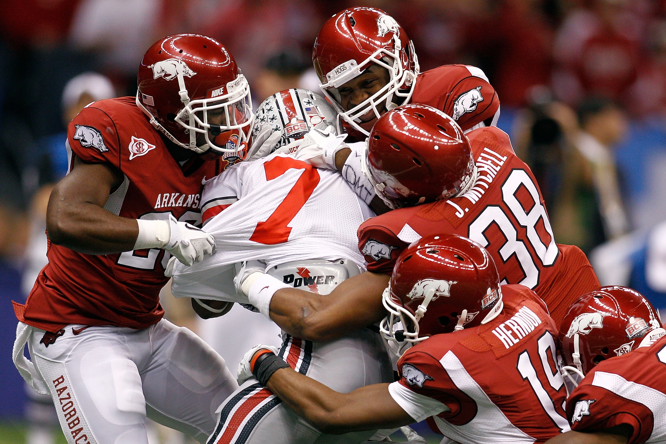NEW ORLEANS, LA - JANUARY 04:  Jordan Hall #7 of the Ohio State Buckeyes is tackled by five Arkansas Razorbacks defenders in the fourth quarter during the Allstate Sugar Bowl at the Louisiana Superdome on January 4, 2011 in New Orleans, Louisiana.  (Photo