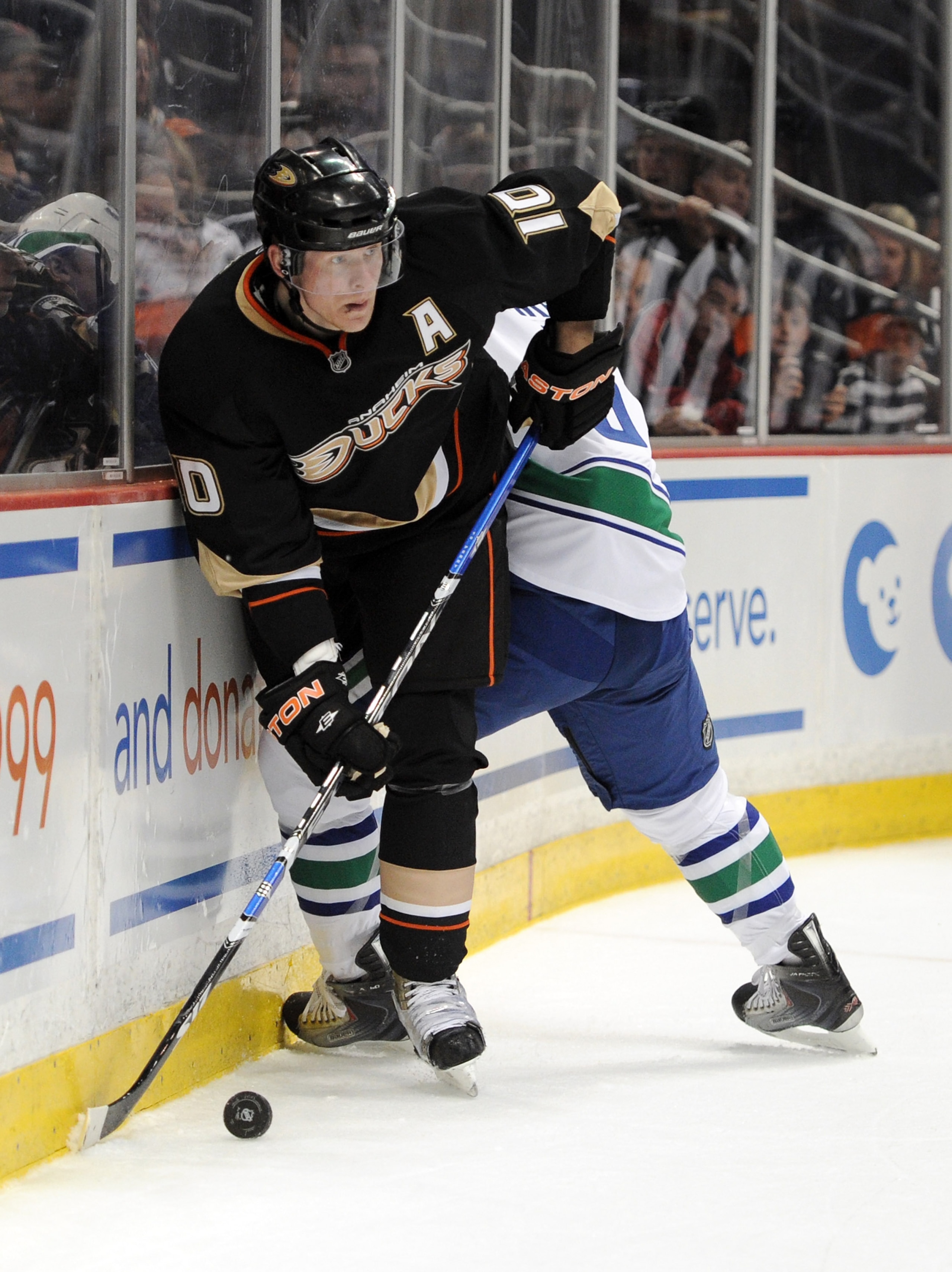 ANAHEIM, CA - MARCH 06: Corey Perry #10 of the Anaheim Ducks looks to pass as he is pinned to the boards by Christian Ehrhoff #5 of the Vancouver Canucks during the first period at the Honda Center on March 6, 2011 in Anaheim, California. (Photo by Harr ANAHEIM, CA - MARCH 06: Corey Perry #10 of the Anaheim Ducks looks to pass as he is pinned to the boards by Christian Ehrhoff #5 of the Vancouver Canucks during the first period at the Honda Center on March 6, 2011 in Anaheim, California. (Photo by Harr