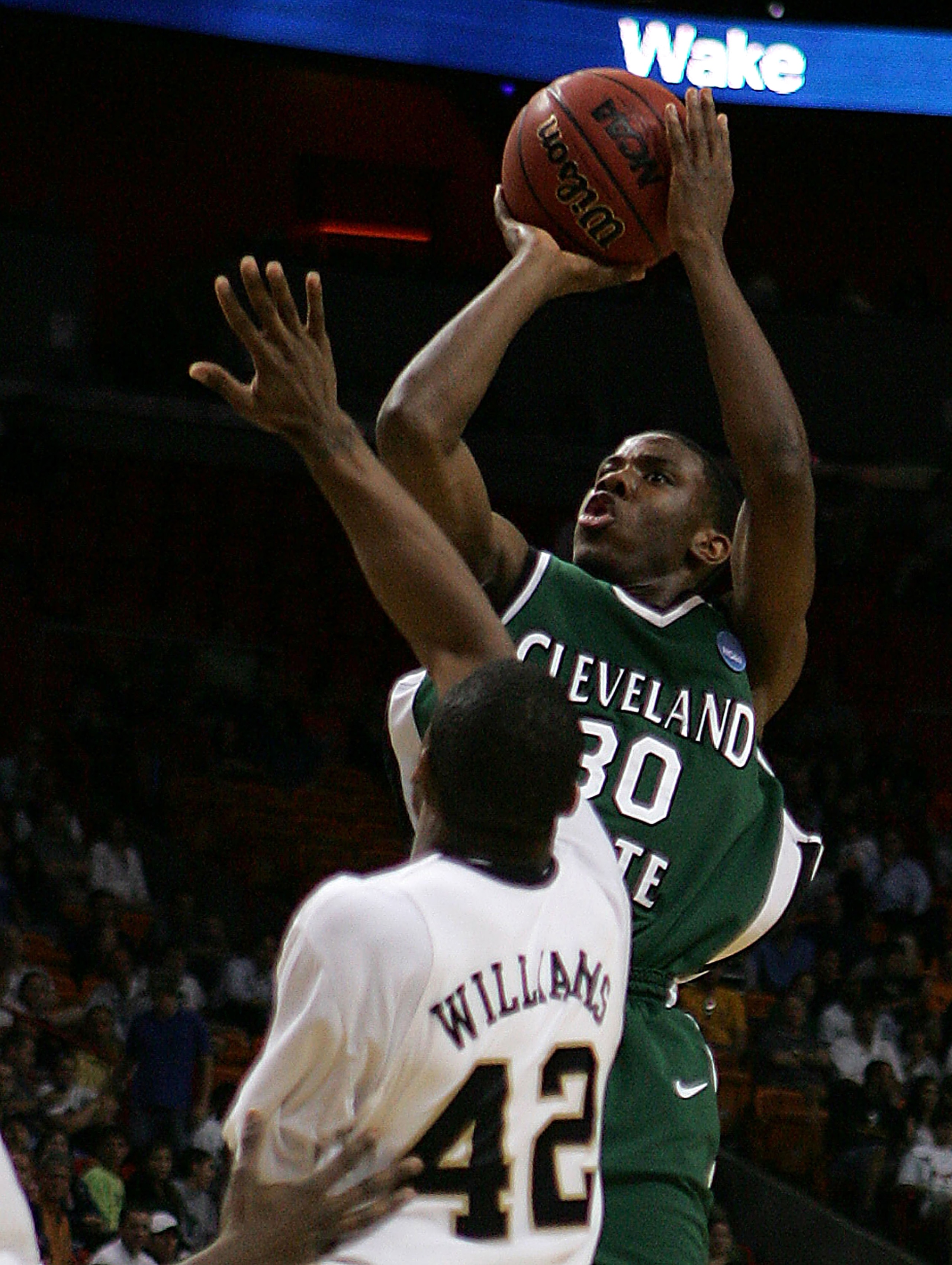 MIAMI - MARCH 20: Guard Norris Cole #30 (R) of the Cleveland State University Vikings takes a shot over guard L.D. Williams #42 (L) of Wake Forest Demon Deacons during the first round of the NCAA Division I Men's Basketball Tournament at the American Ai MIAMI - MARCH 20: Guard Norris Cole #30 (R) of the Cleveland State University Vikings takes a shot over guard L.D. Williams #42 (L) of Wake Forest Demon Deacons during the first round of the NCAA Division I Men's Basketball Tournament at the American Ai