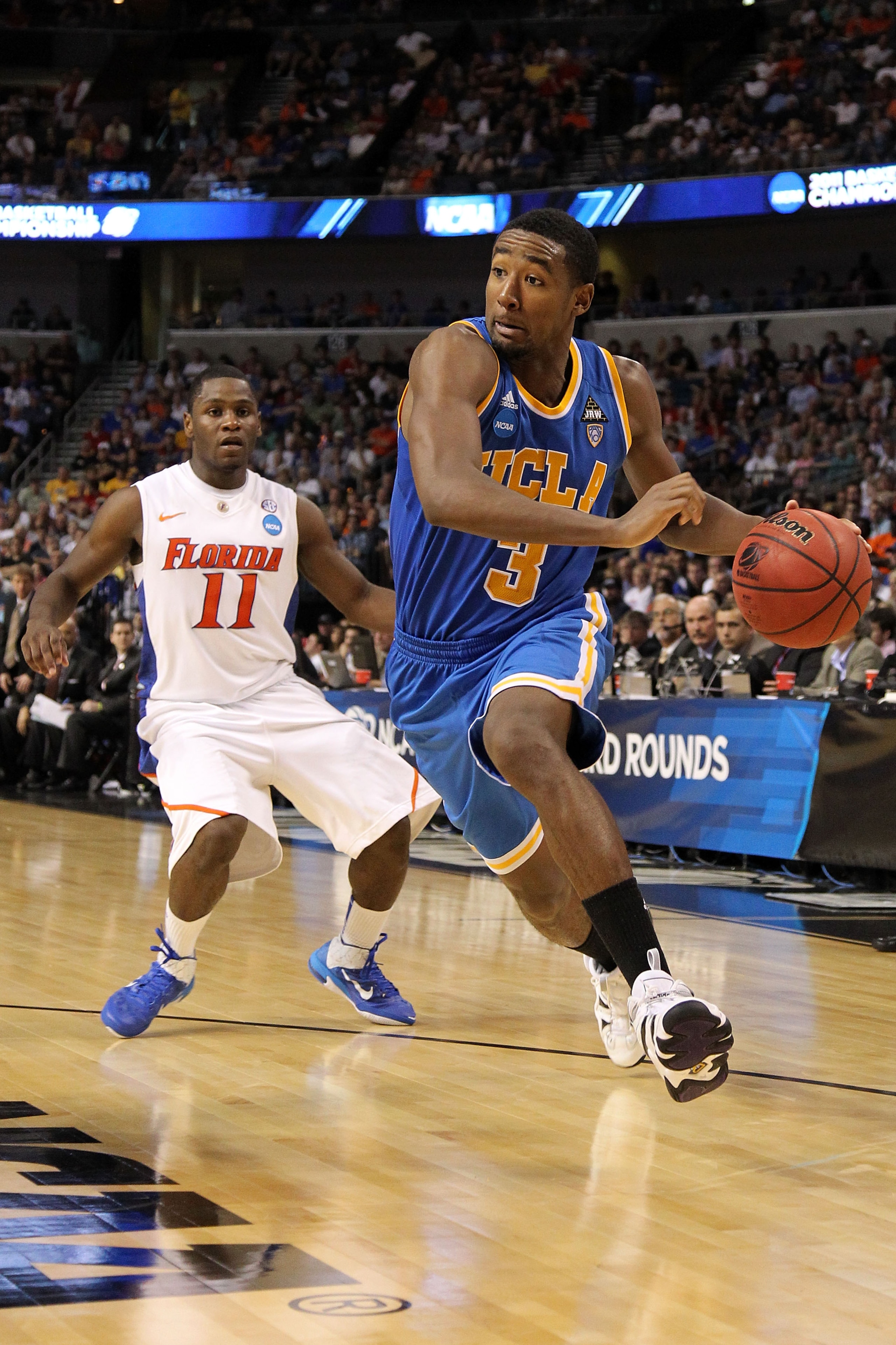 TAMPA, FL - MARCH 19: Malcolm Lee #3 of the UCLA Bruins drives against Erving Walker #11 of the Florida Gators during the third round of the 2011 NCAA men's basketball tournament at St. Pete Times Forum on March 19, 2011 in Tampa, Florida. (Photo by Mik TAMPA, FL - MARCH 19: Malcolm Lee #3 of the UCLA Bruins drives against Erving Walker #11 of the Florida Gators during the third round of the 2011 NCAA men's basketball tournament at St. Pete Times Forum on March 19, 2011 in Tampa, Florida. (Photo by Mik