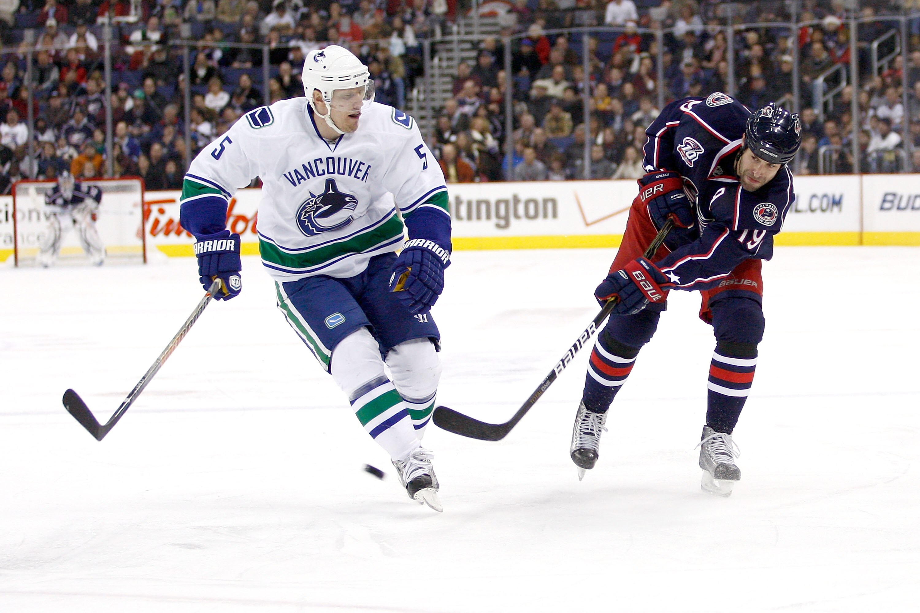 COLUMBUS, OH - DECEMBER 23:  Ethan Moreau #19 of the Columbus Blue Jackets shoots the puck past Christian Ehrhoff #5 of the Vancouver Canucks during the second period on December 23, 2010 at Nationwide Arena in Columbus, Ohio.  (Photo by John Grieshop/Get