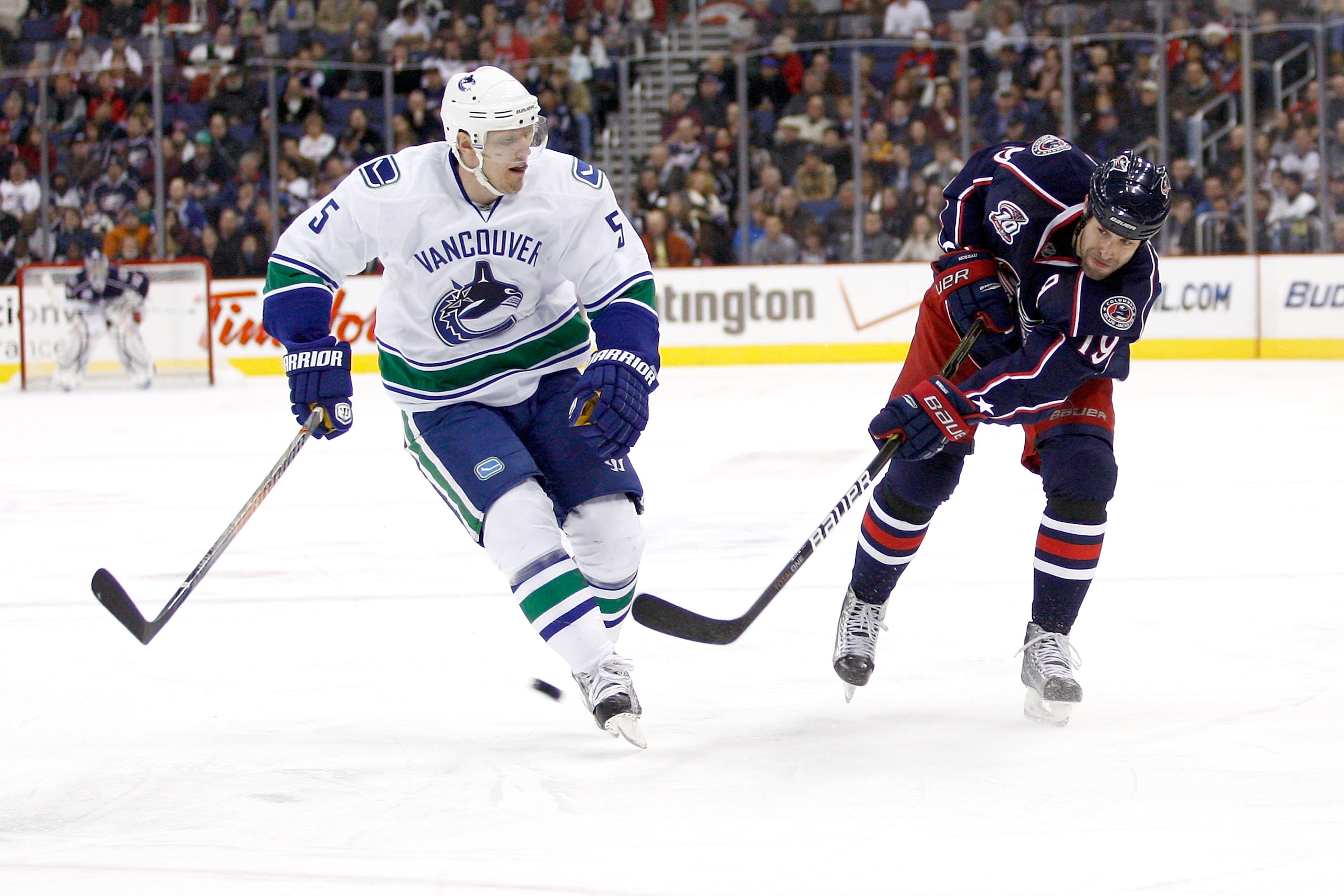 COLUMBUS, OH - DECEMBER 23:  Ethan Moreau #19 of the Columbus Blue Jackets shoots the puck past Christian Ehrhoff #5 of the Vancouver Canucks during the second period on December 23, 2010 at Nationwide Arena in Columbus, Ohio.  (Photo by John Grieshop/Get