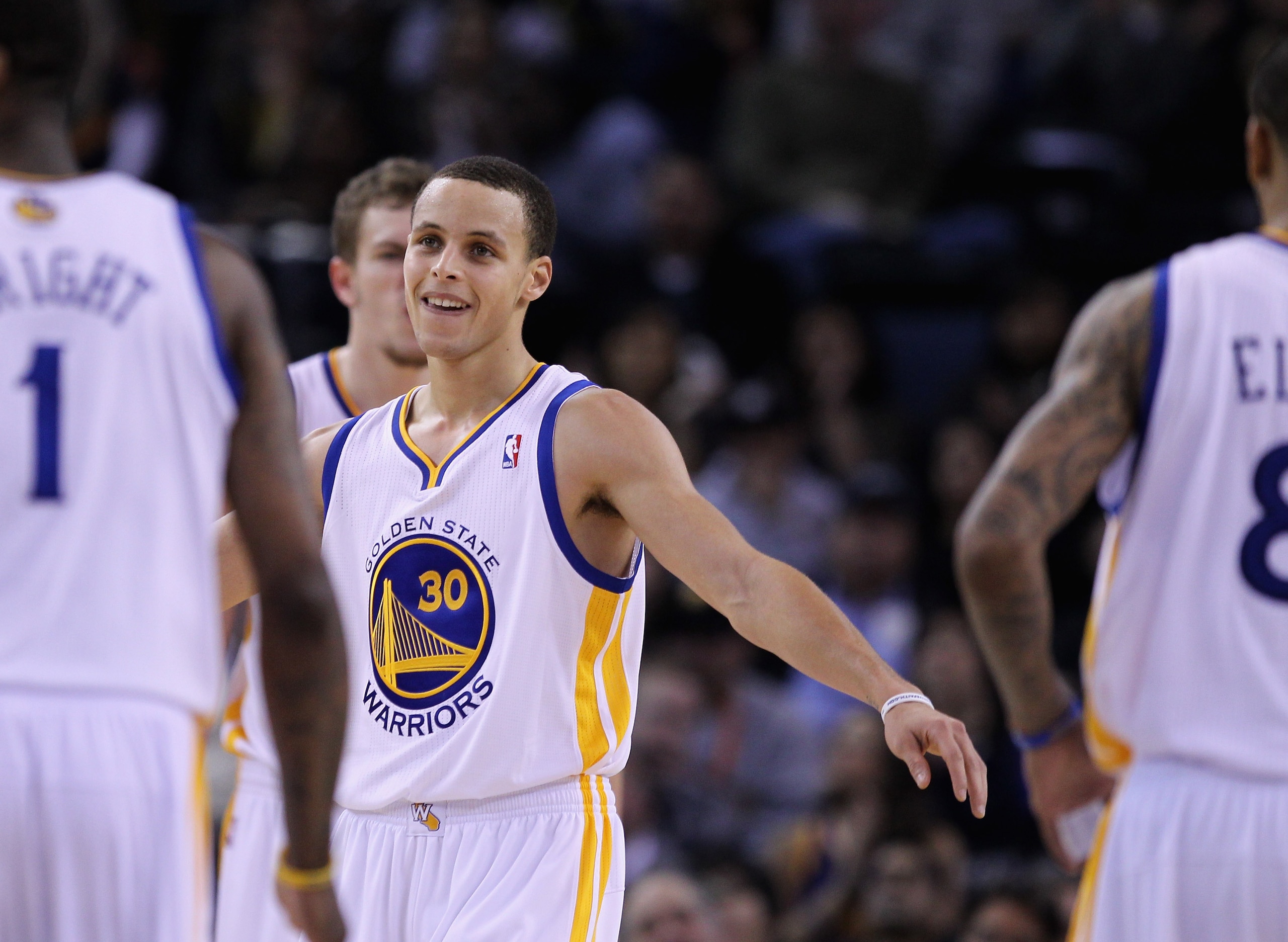 OAKLAND, CA - MARCH 25:  Stephen Curry #30 of the Golden State Warriors congratulates his teammates during their game against the Toronto Raptors at Oracle Arena on March 25, 2011 in Oakland, California. NOTE TO USER: User expressly acknowledges and agree