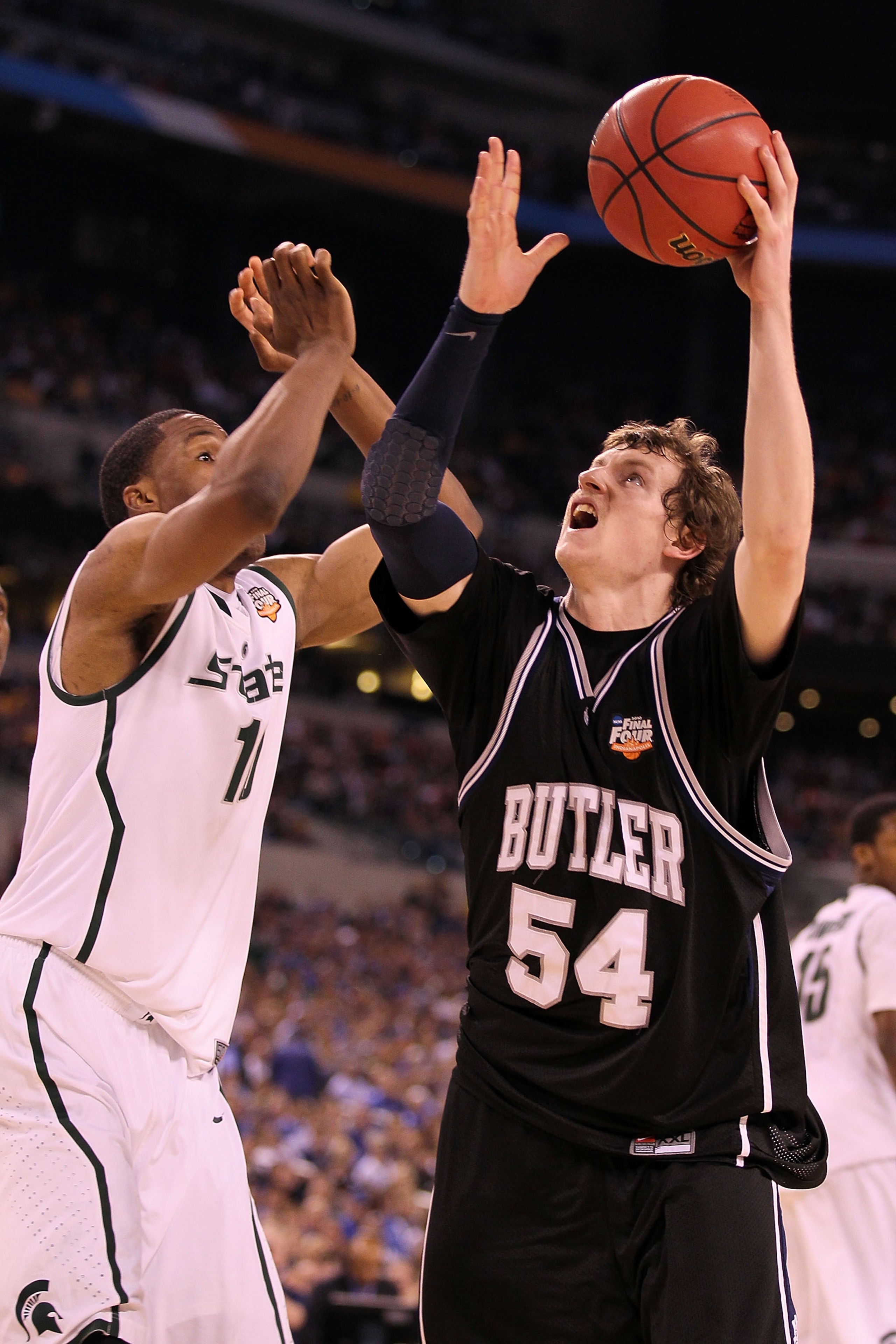 INDIANAPOLIS - APRIL 03:  Matt Howard #54 of the Butler Bulldogs goes up for a shot over Delvon Roe #10 of the Michigan State Spartans in the second half during the National Semifinal game of the 2010 NCAA Division I Men's Basketball Championship on April