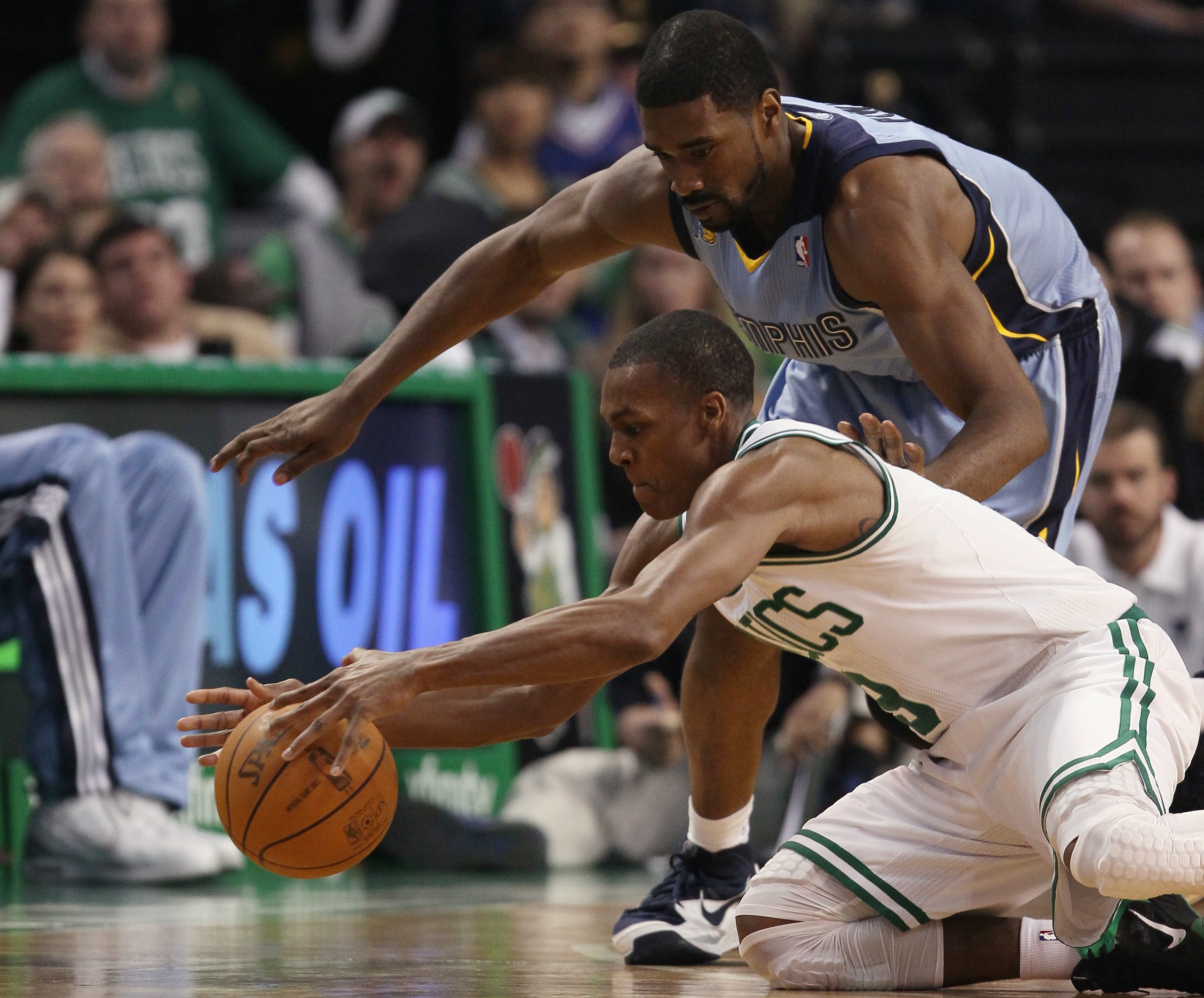 BOSTON, MA - MARCH 23:  Rajon Rondo #9 of the Boston Celtics and Leon Powe #7 of the Memphis Grizzlies fight for the ball on March 23, 2011 at the TD Garden in Boston, Massachusetts.  The Memphis Grizzlies defeated the Boston Celtics 90-87. NOTE TO USER:
