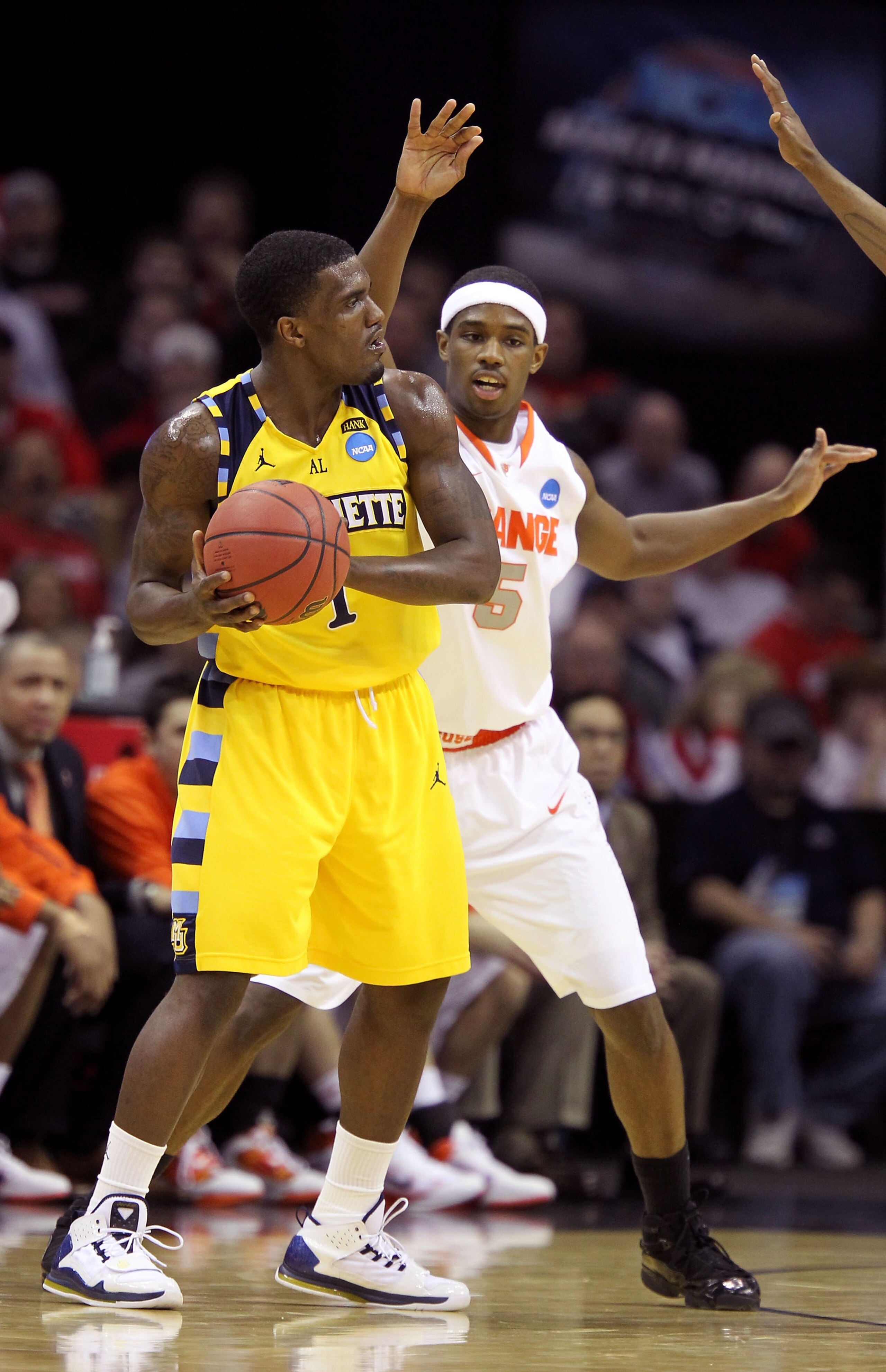 CLEVELAND, OH - MARCH 20: Darius Johnson-Odom #1 of the Marquette Golden Eagles handles the ball against C.J. Fair #5 of the Syracuse Orange during the third of the 2011 NCAA men's basketball tournament at Quicken Loans Arena on March 20, 2011 in Clevelan