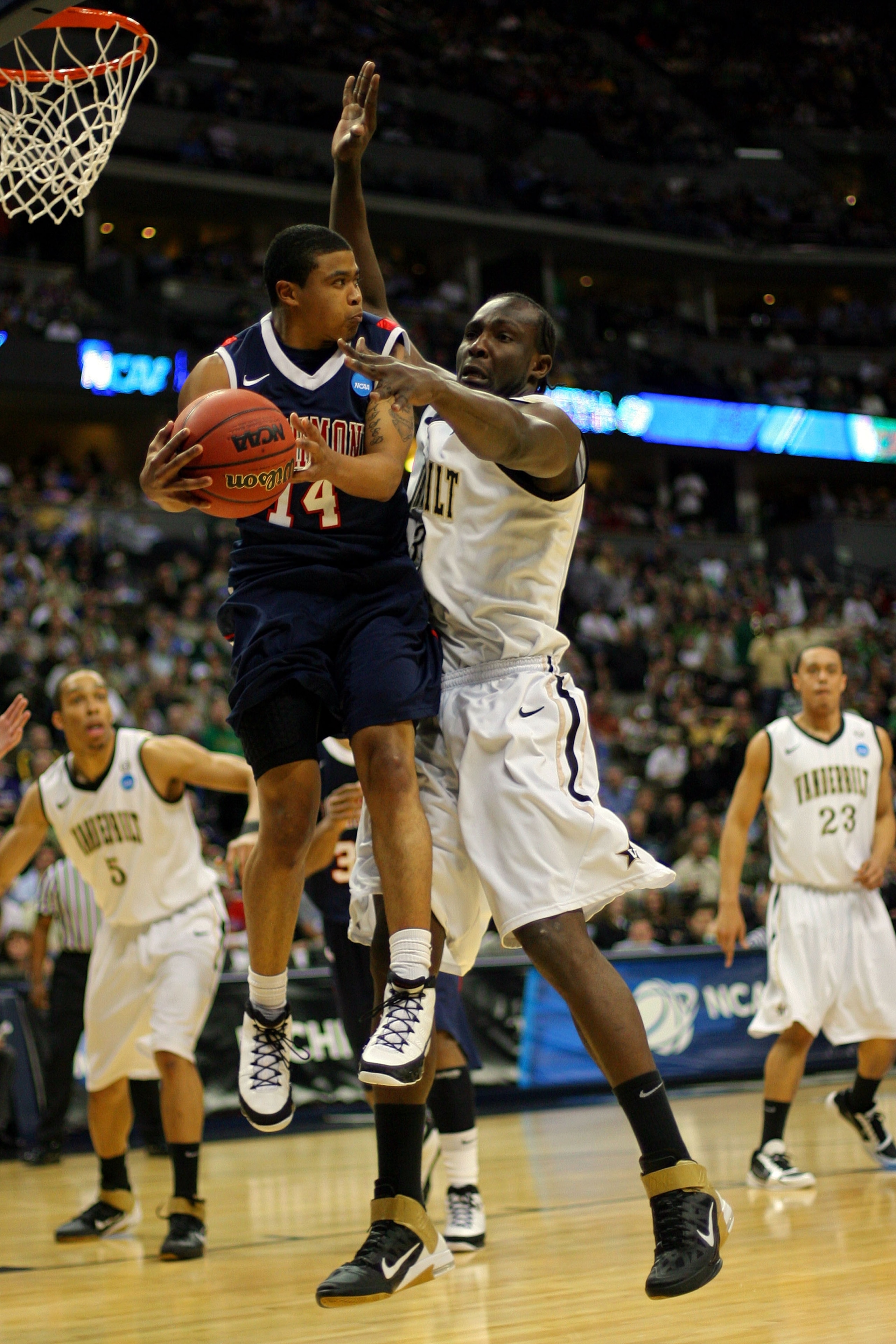 DENVER, CO - MARCH 17:  Kevin Anderson #14 of the Richmond Spiders handles the ball against Steve Tchiengang #33 of the Vanderbilt Commodores during the second round of the 2011 NCAA men's basketball tournament at Pepsi Center on March 17, 2011 in Denver,