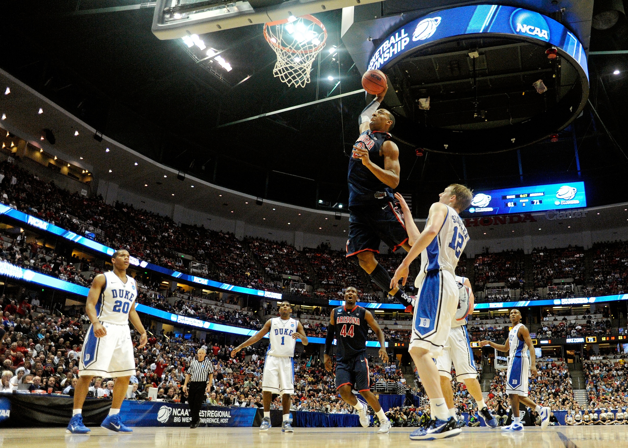 ANAHEIM, CA - MARCH 24:  Derrick Williams #23 of the Arizona Wildcats dunks the over Kyle Singler #12 of the Duke Blue Devils during the west regional semifinal of the 2011 NCAA men's basketball tournament at the Honda Center on March 24, 2011 in Anaheim,