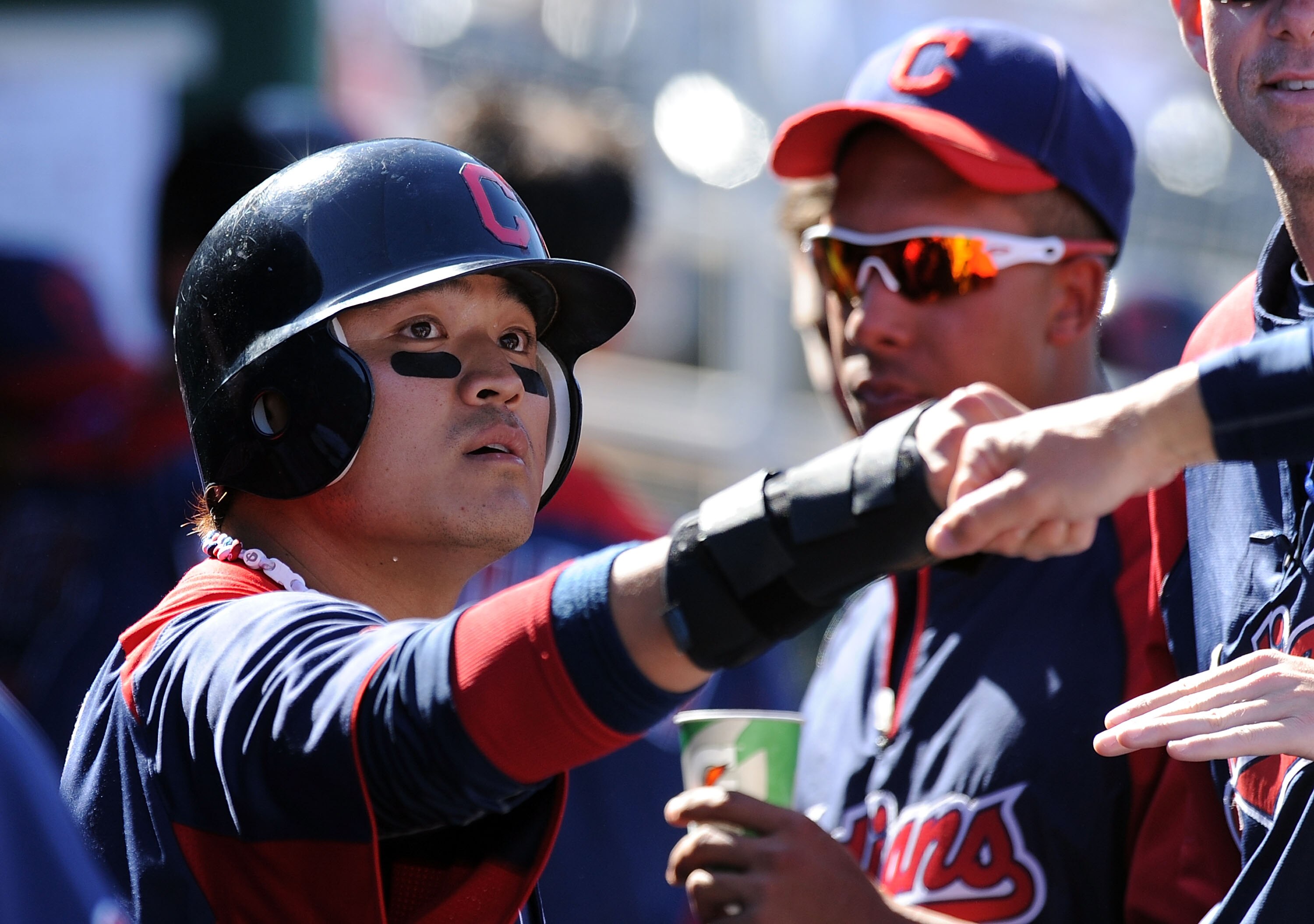 GOODYEAR, AZ - MARCH 11:  Shin-Soo Choo #17 of the Cleveland Indians gets congratulated by a teammate after scoring a run against the Seattle Mariners at Goodyear Ballpark on March 11, 2011 in Goodyear, Arizona.  (Photo by Norm Hall/Getty Images)